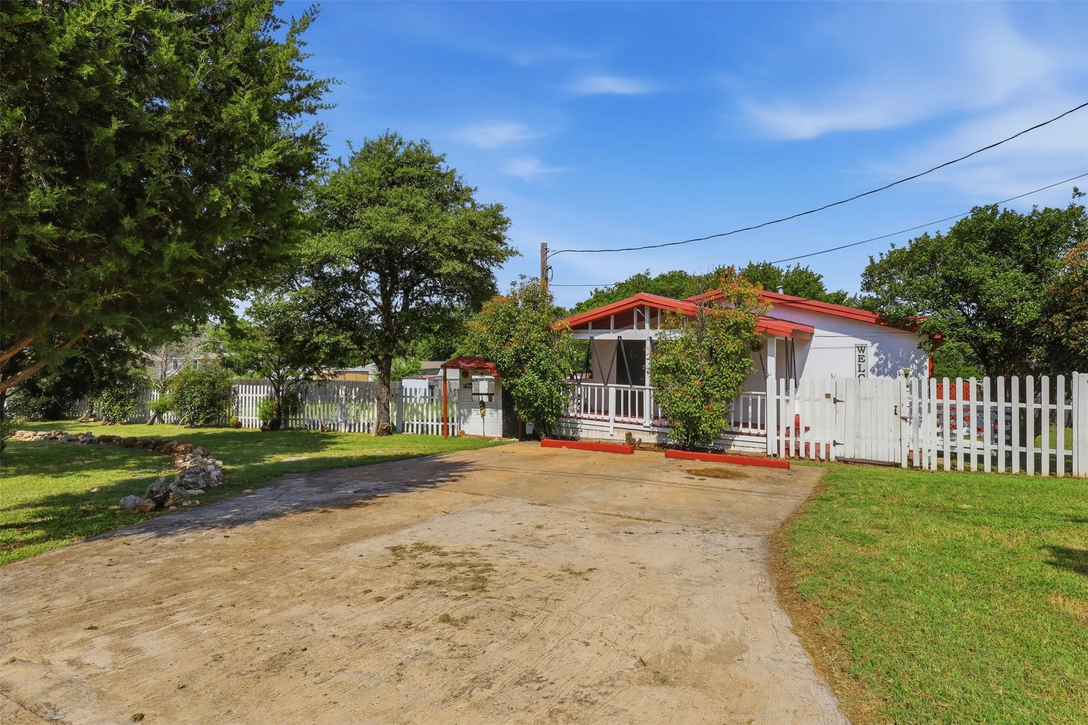 Side of home with covered porch and driveway.