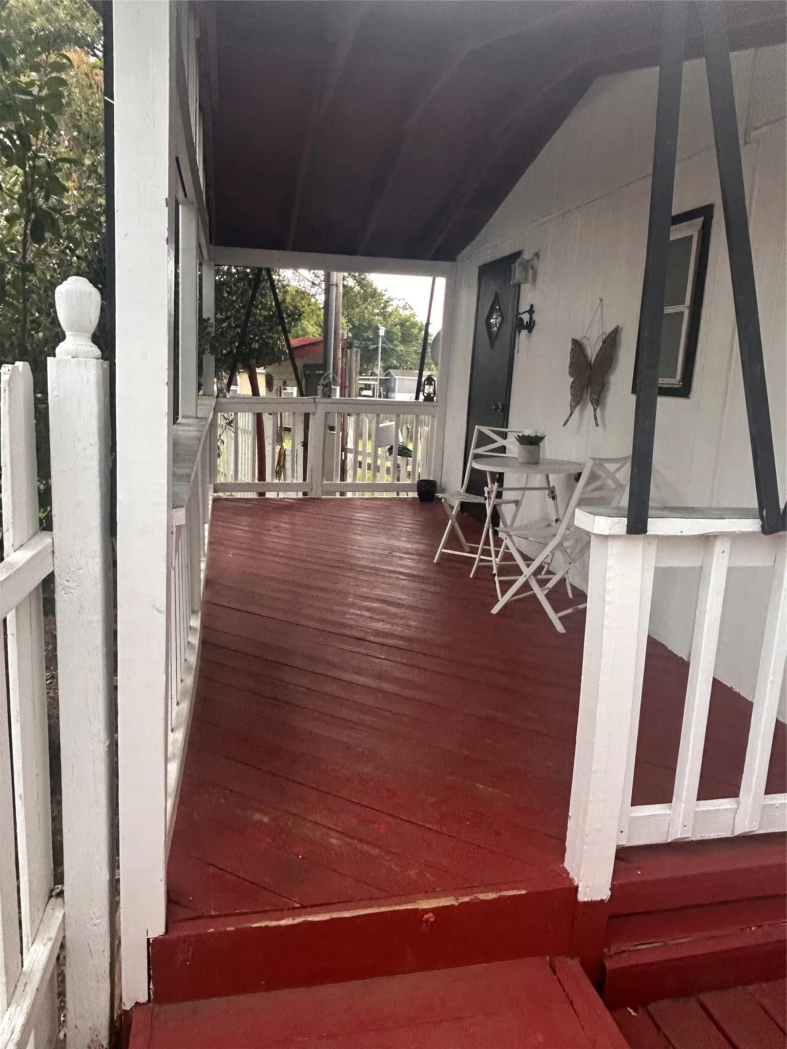View of covered porch on the side of home.