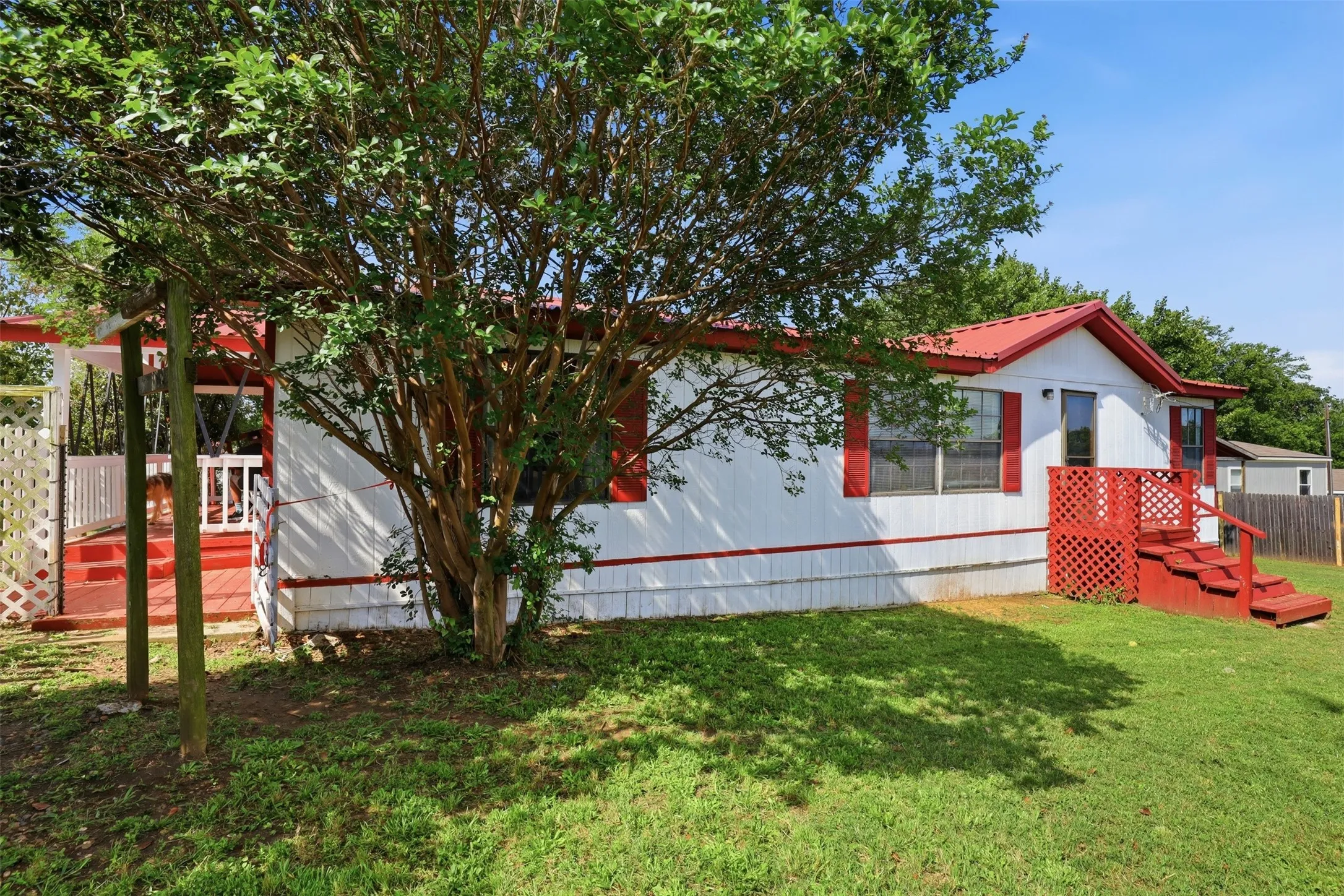 View of the other side of the home with the side covered porch.