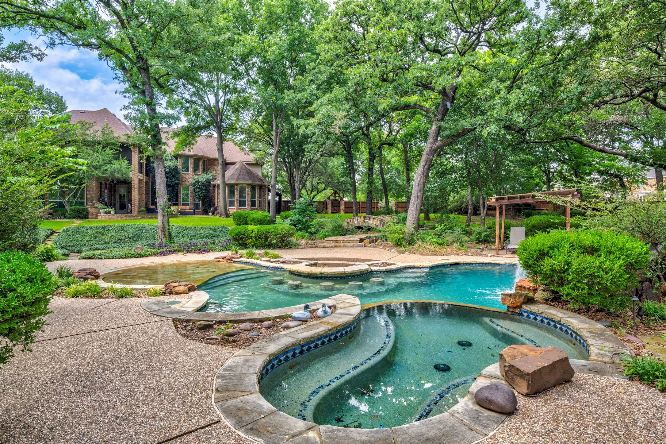 Salt water pool with beach entry, waterfalls, stools, and 12 person spa!