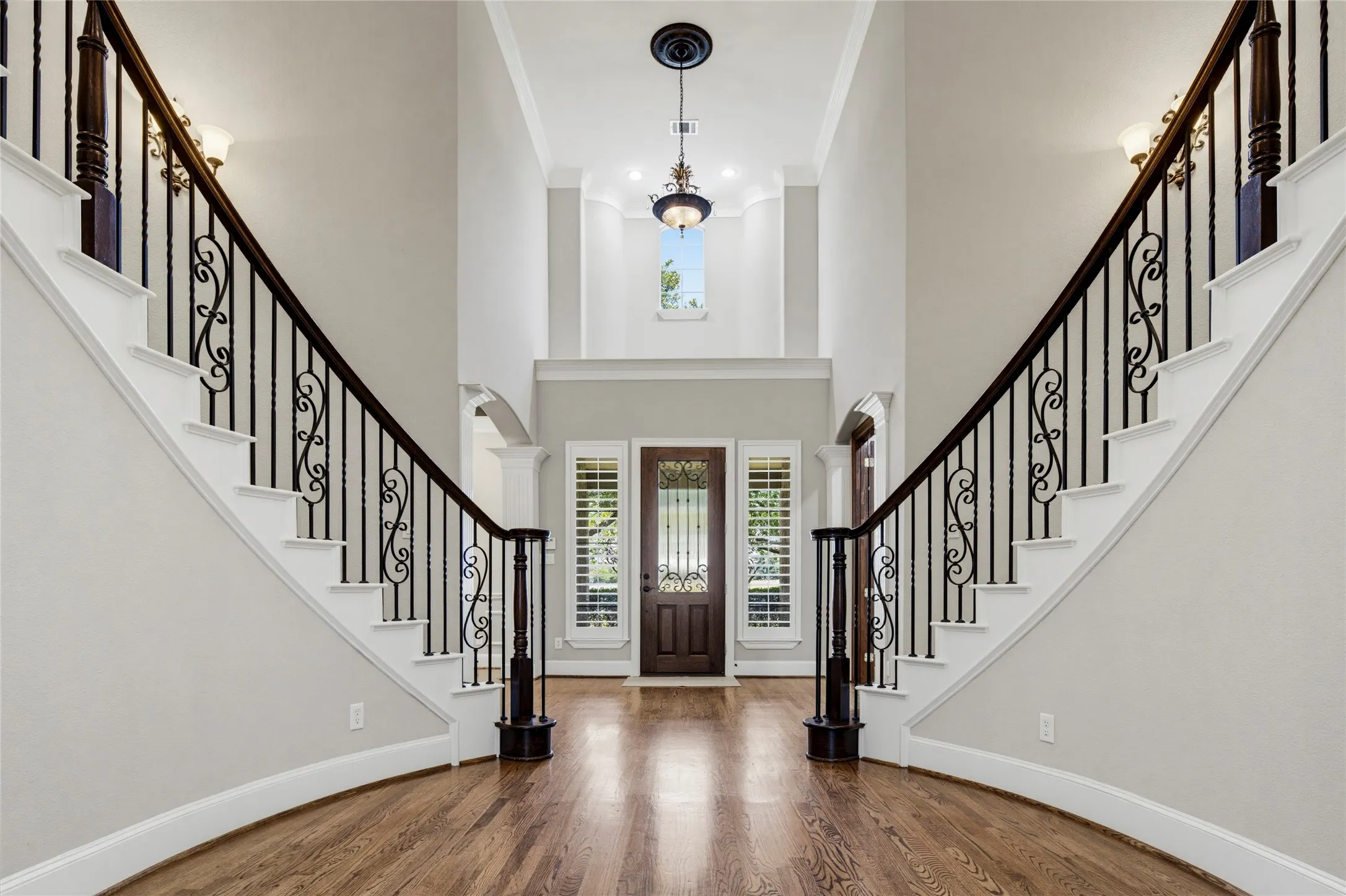 The quality of workmanship is evident upon entry! Two grand staircases anchor the spacious foyer & lead to the formal living room with a focal gas fireplace and bay windows overlooking the backyard.