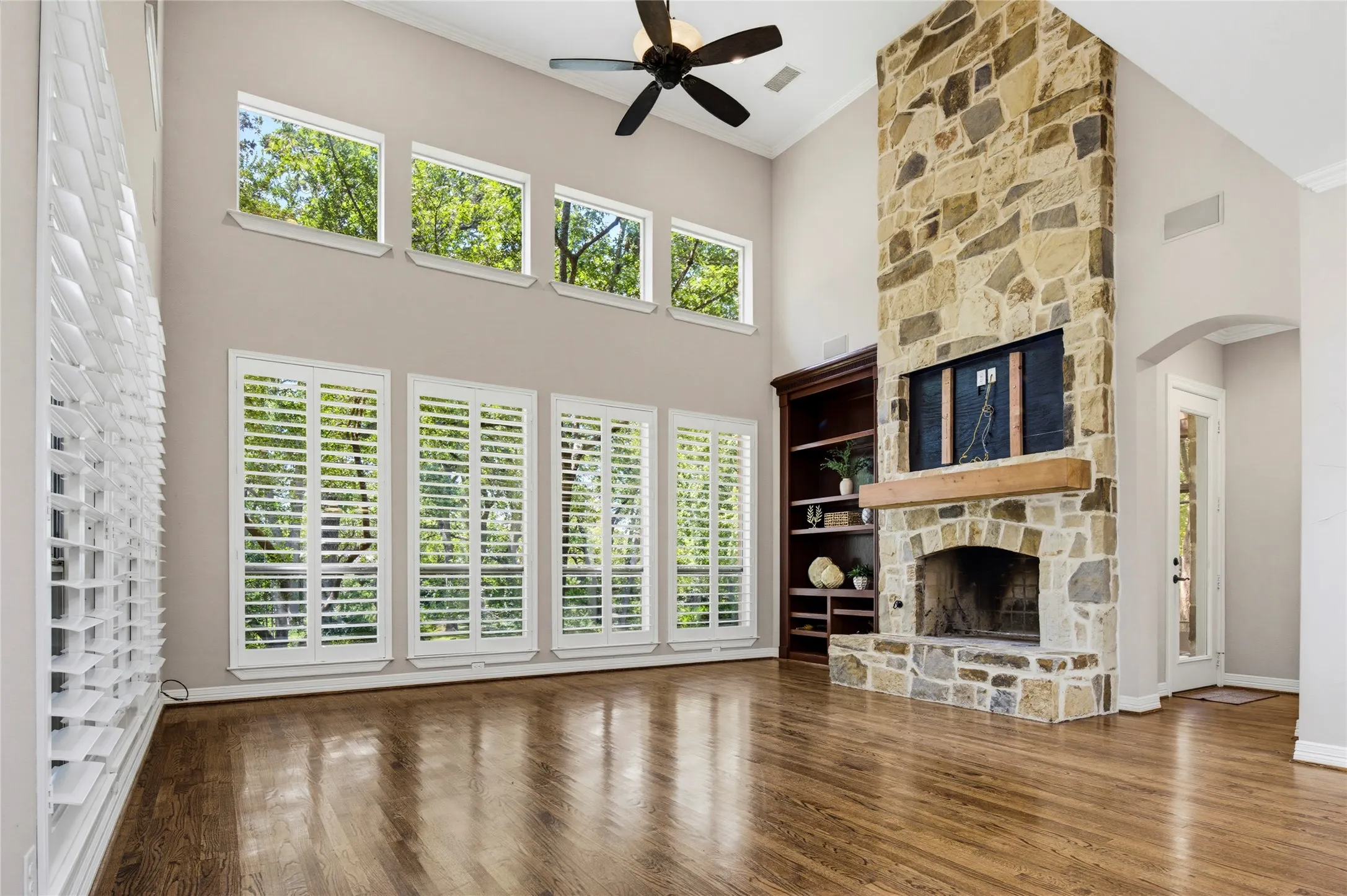 The 19 x 17 family room enjoys an incredible 2 story stone wood-burning fireplace and picture windows framing the magical backyard setting.