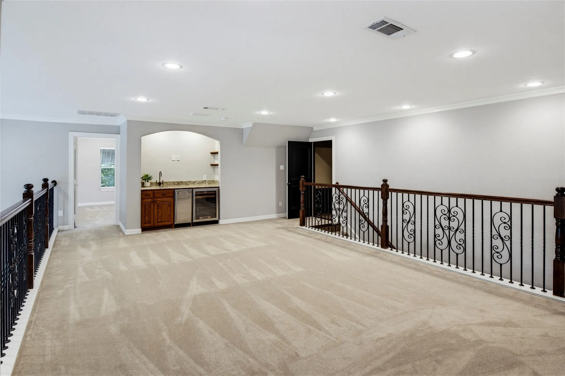 Game room with wet bar and door leading out to a screened-in covered balcony.