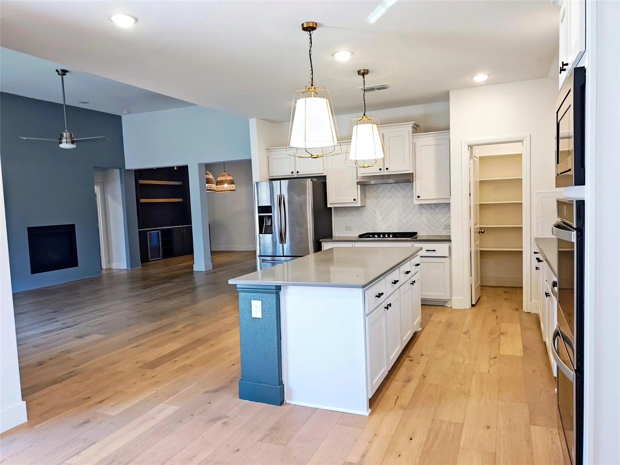 Gourmet kitchen with a large center island, built-in stainless steel appliances, and white​​‌​​​​‌​​‌‌​‌‌​​​‌‌​‌​‌​‌​​​‌​​ cabinetry
