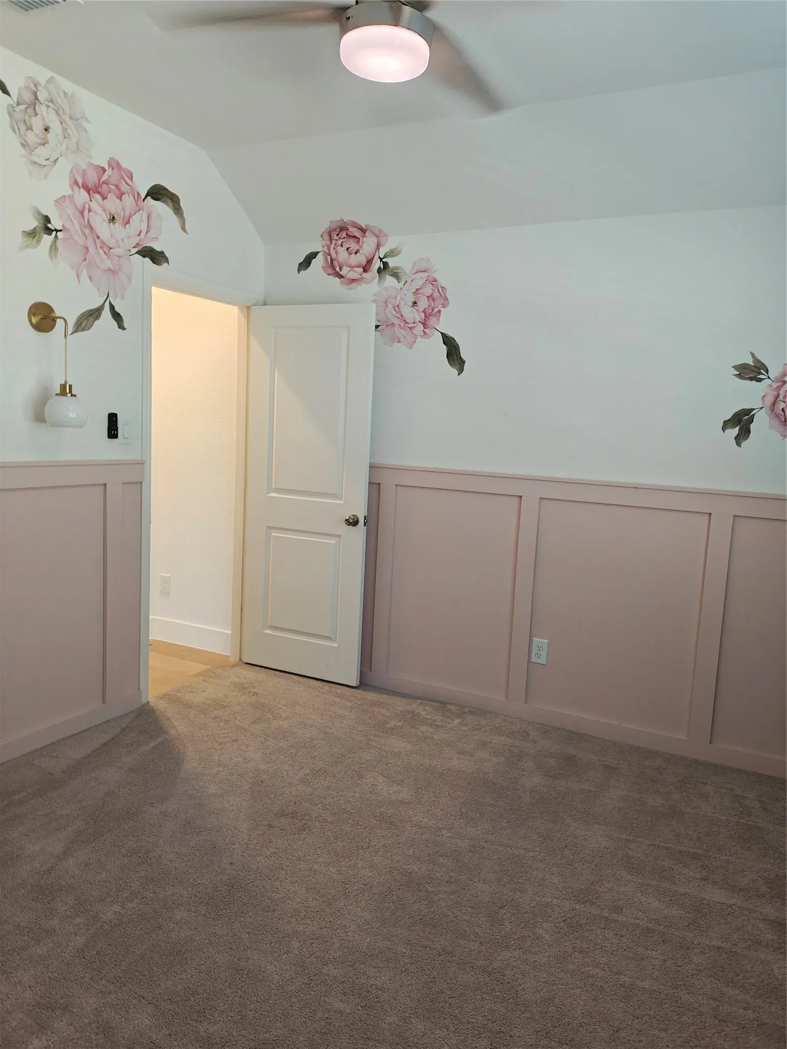 Wall paneling with a subtle pink hue, complemented by a textured carpet flooring