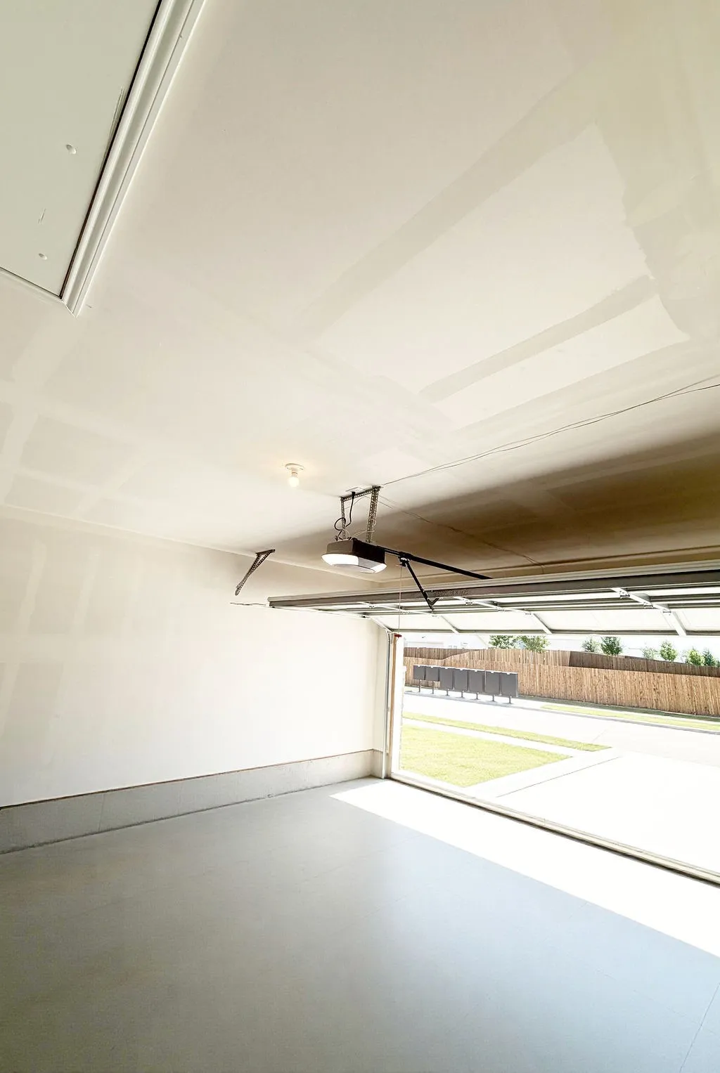 Attached garage featuring light-toned walls and a durable concrete floor