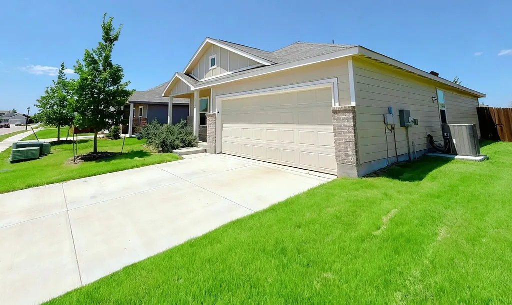 Single-story residence featuring a two-car garage with a paneled door