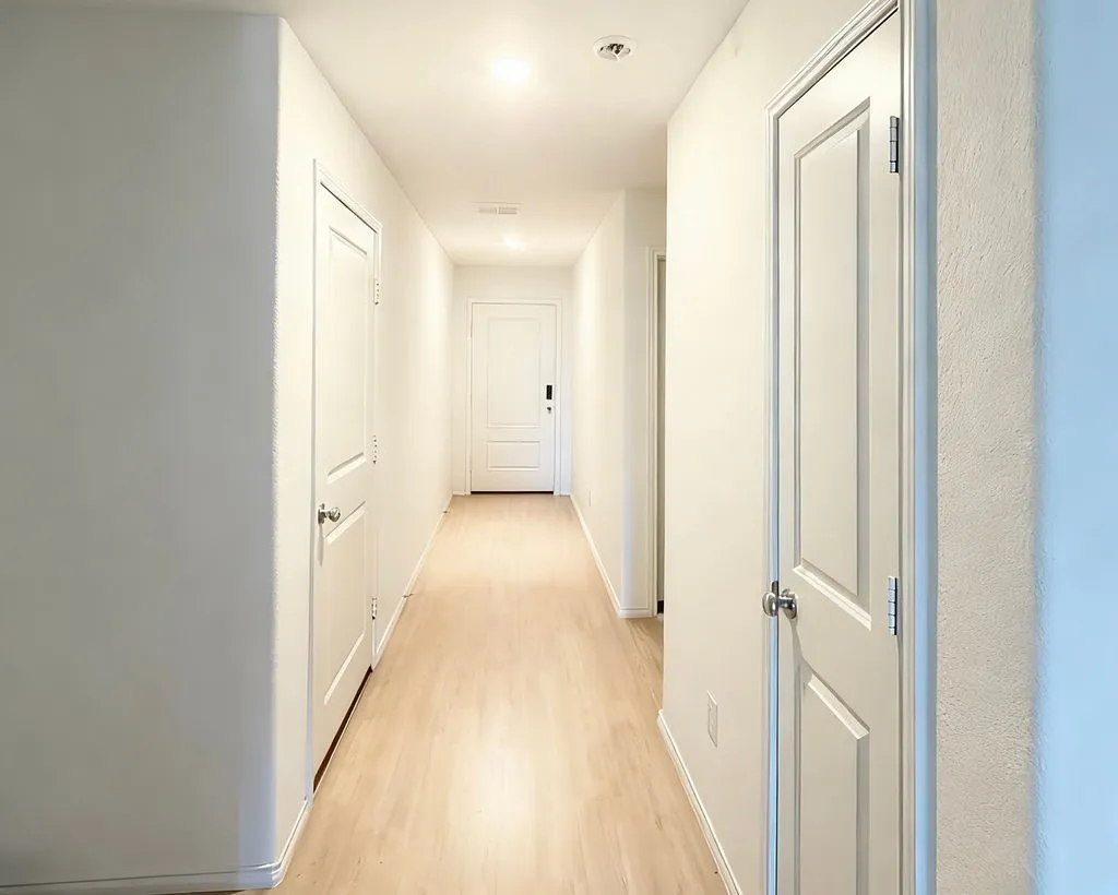 Hallway featuring light wood-finish flooring and recessed ceiling lighting