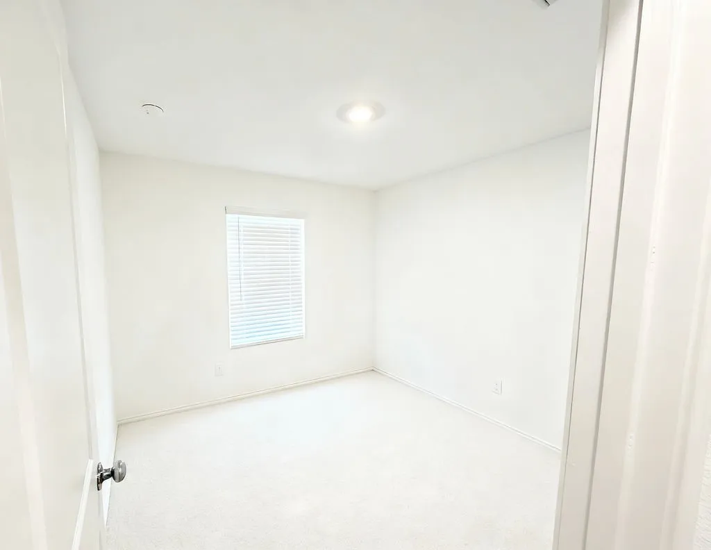 Neutral white-painted room with light-toned carpeting