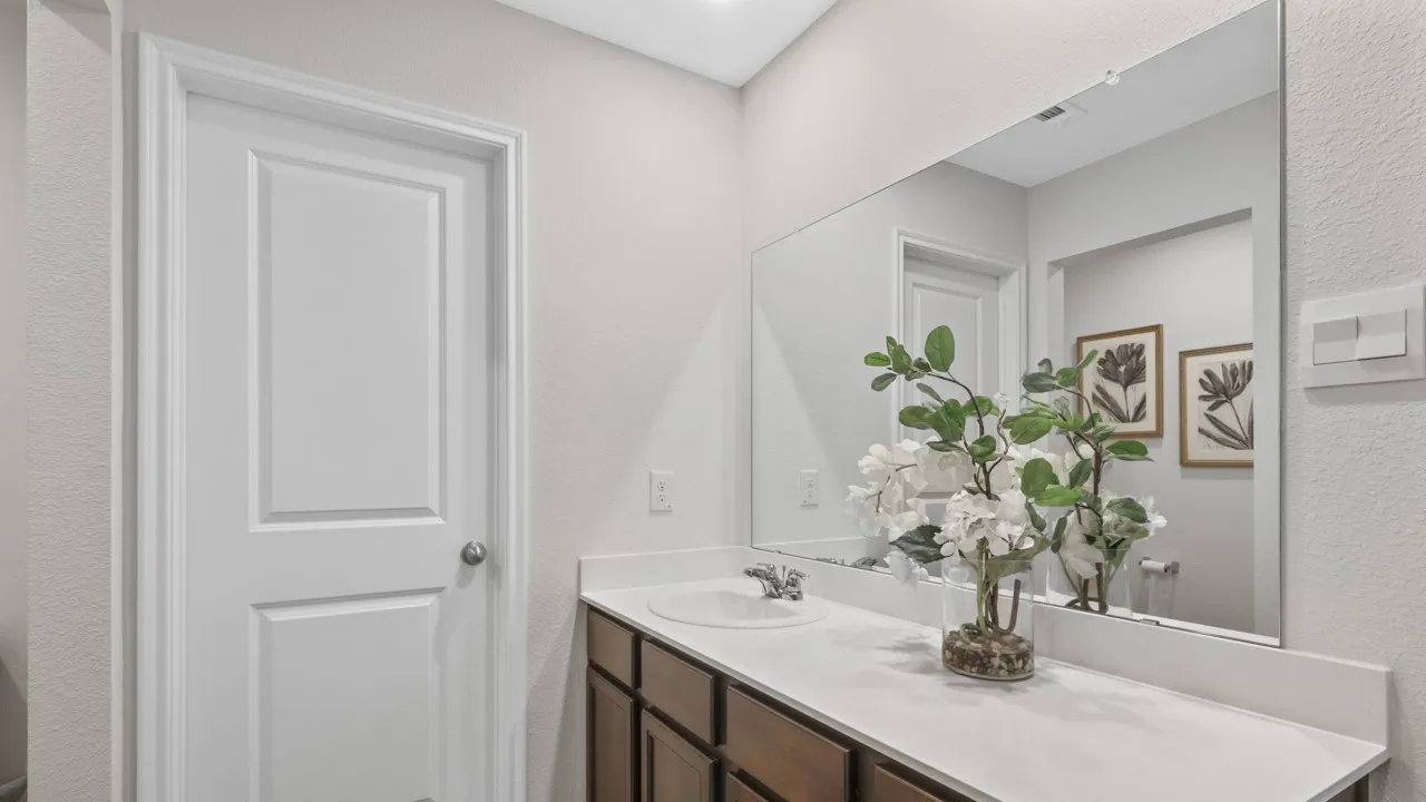 Bathroom vanity with an integrated sink and light-toned countertop