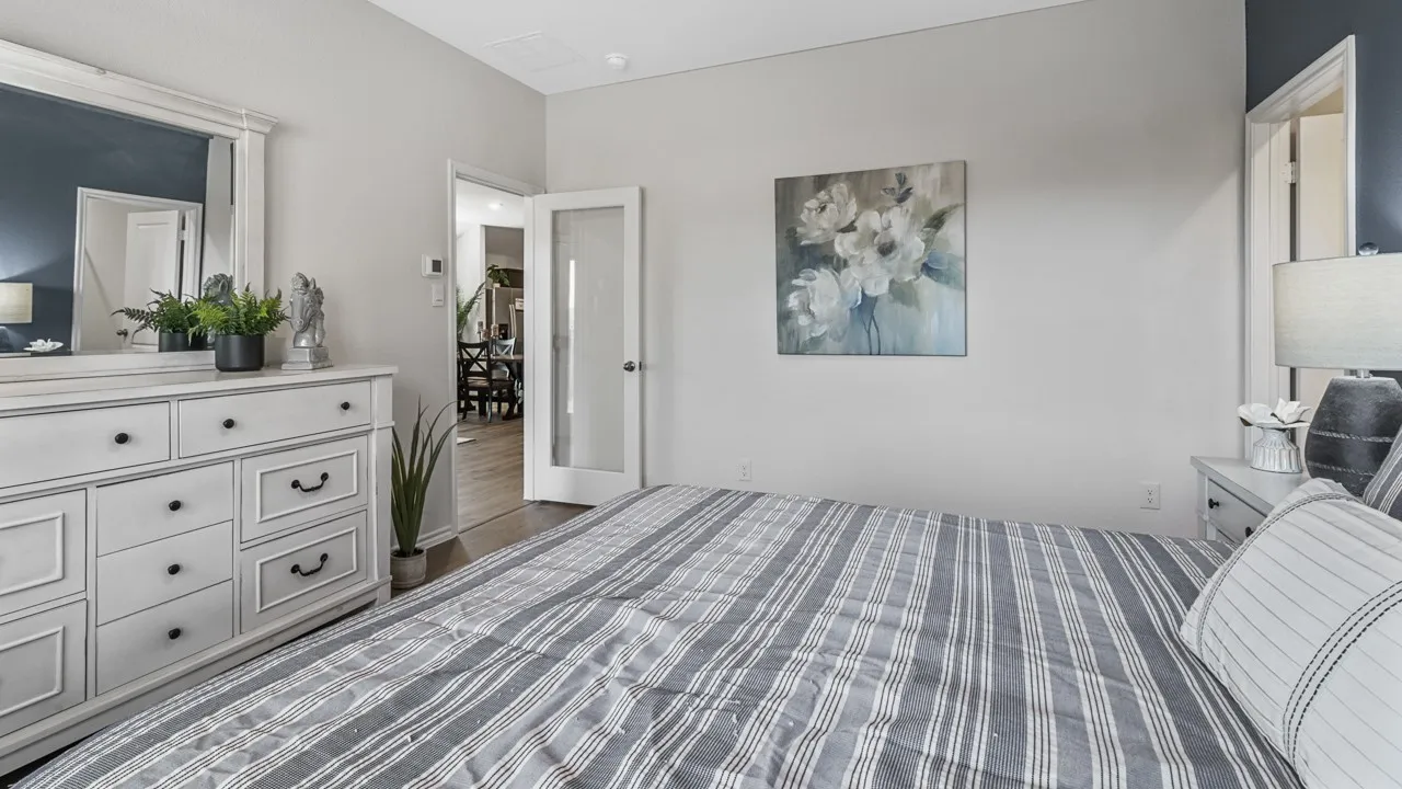 Bedroom with light gray walls and a contrasting accent wall