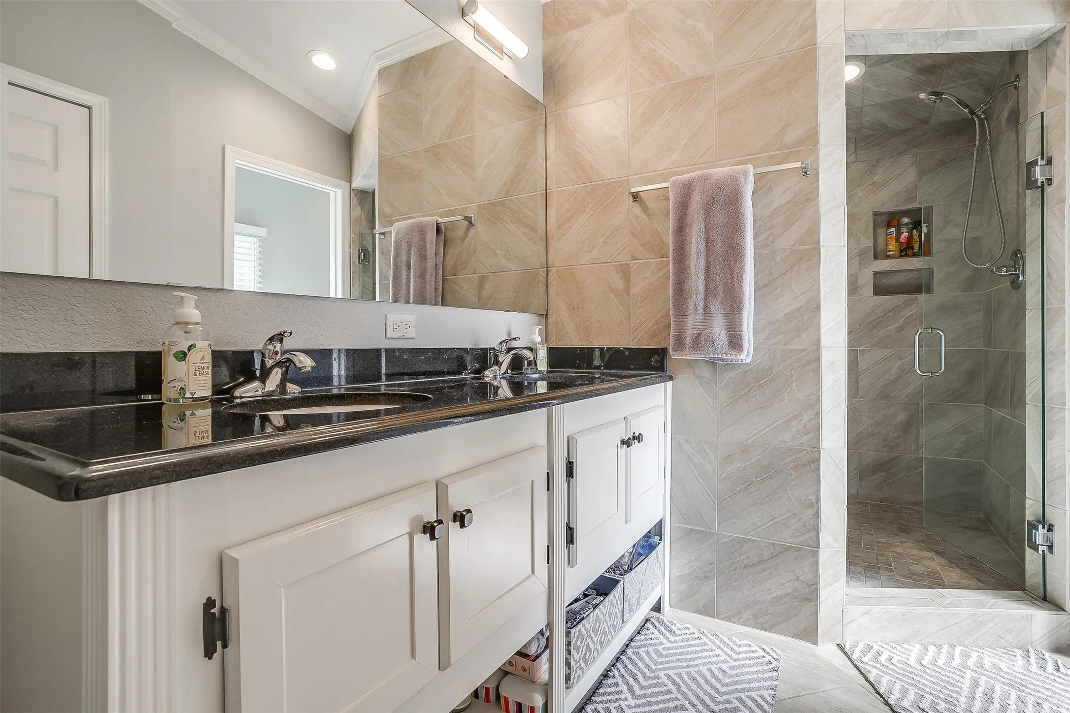 Dual vanity with black countertop and integrated sinks