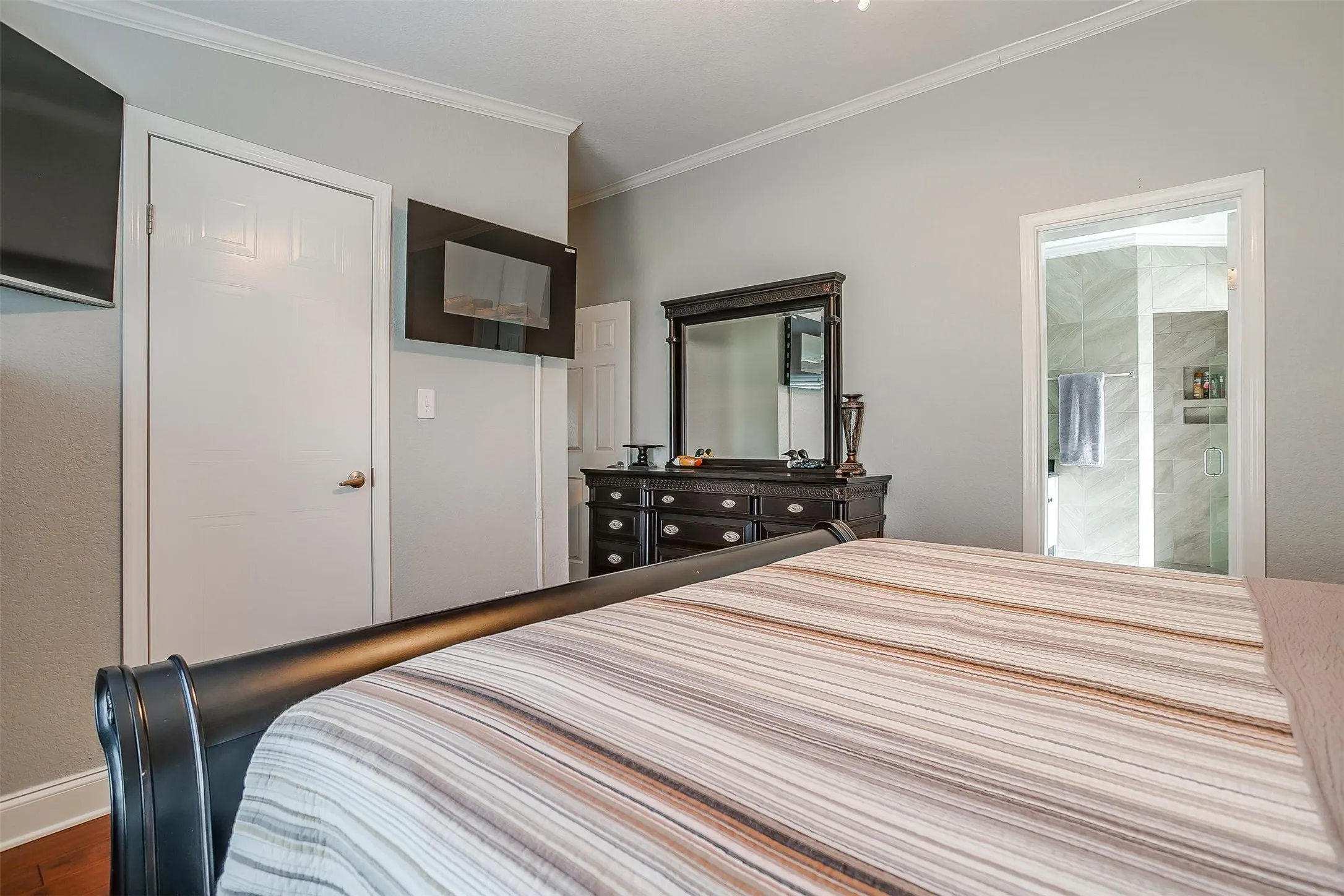 Bedroom featuring light gray walls and crown molding