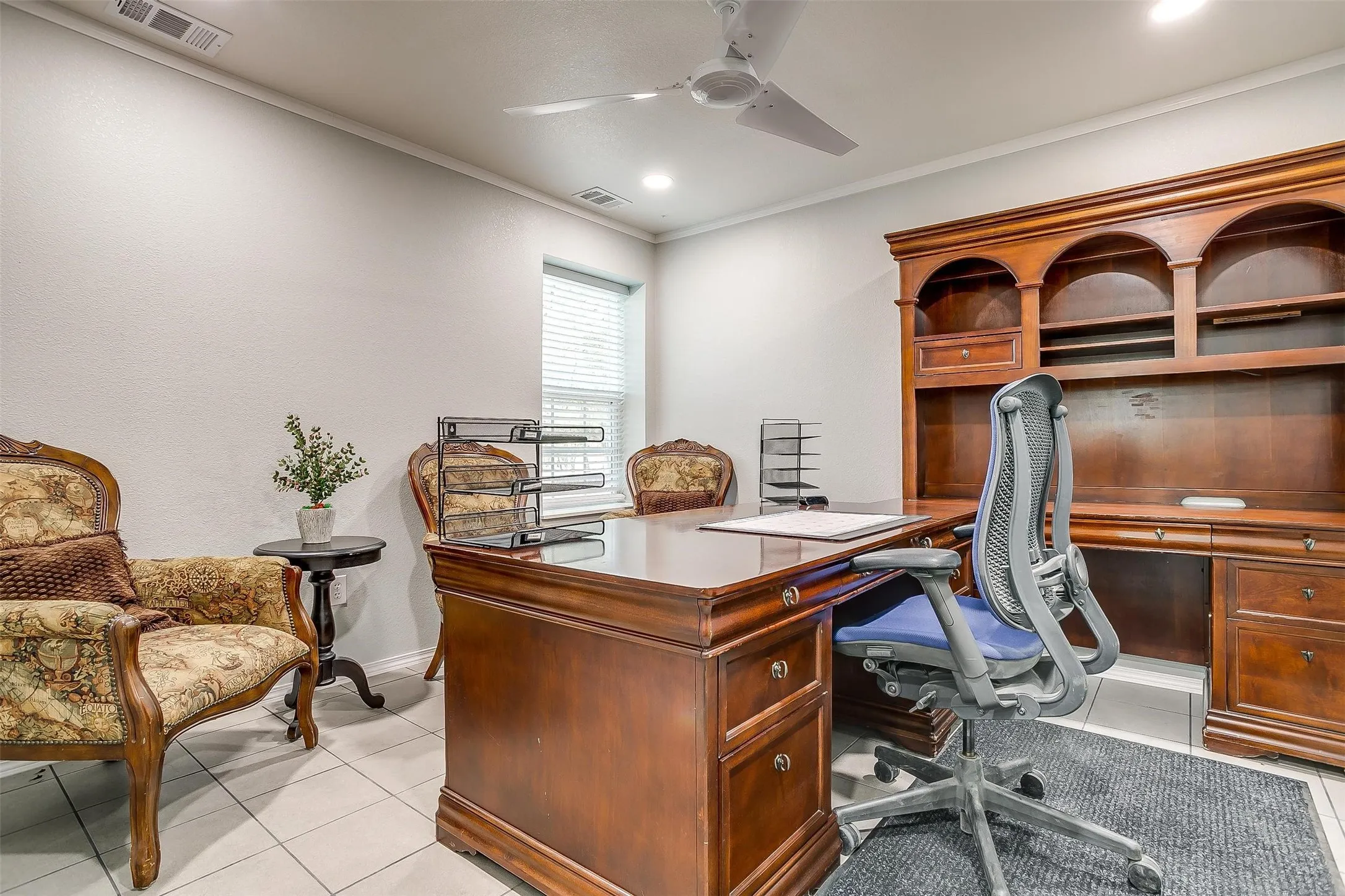 Dedicated workspace featuring light-colored tile flooring