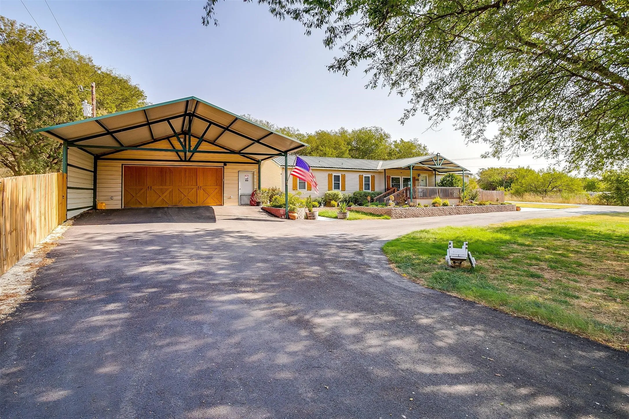 Paved driveway with an attached metal carport offering covered parking