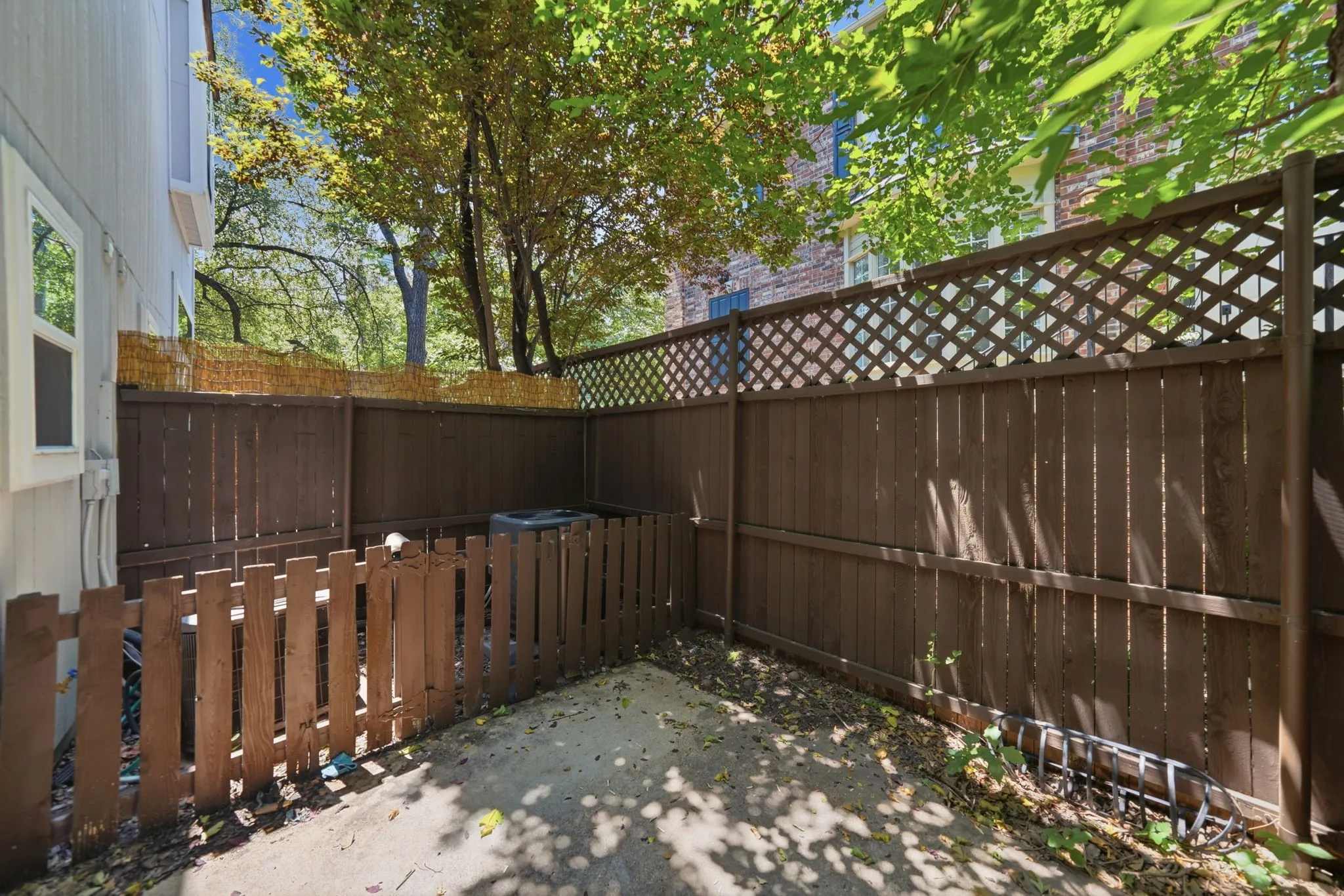 Private outdoor patio space featuring concrete flooring