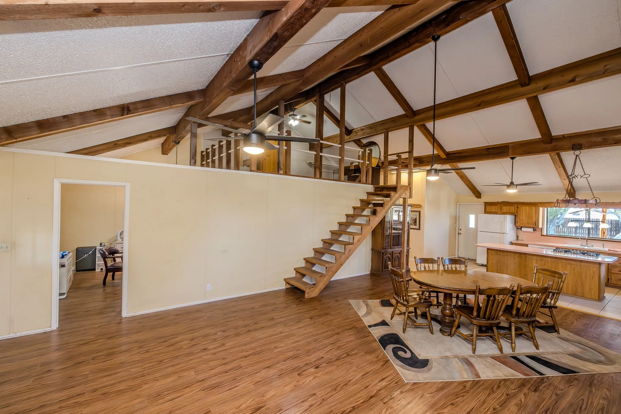 Open ceiling above office (2nd bedroom) and loft (3rd bedroom) at the top of the stairs from the living room; loft could be converted to another use, or enclosed for more privacy.