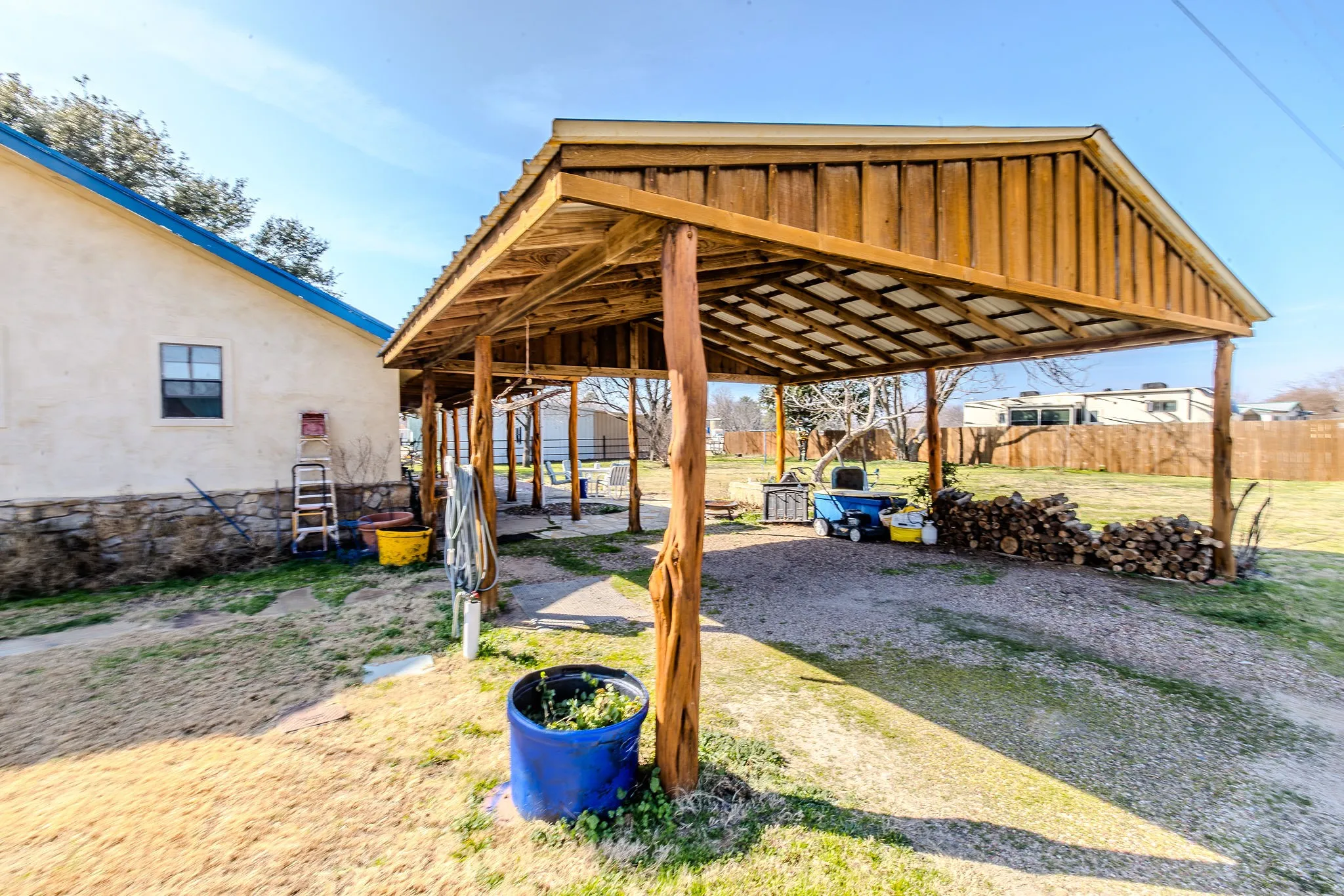 The property features a very large grassy backyard, a variety of trees (oak, pecan, magnolia, and others) and partial fencing to separate it from neighbors (fencing ownership to be verified).
