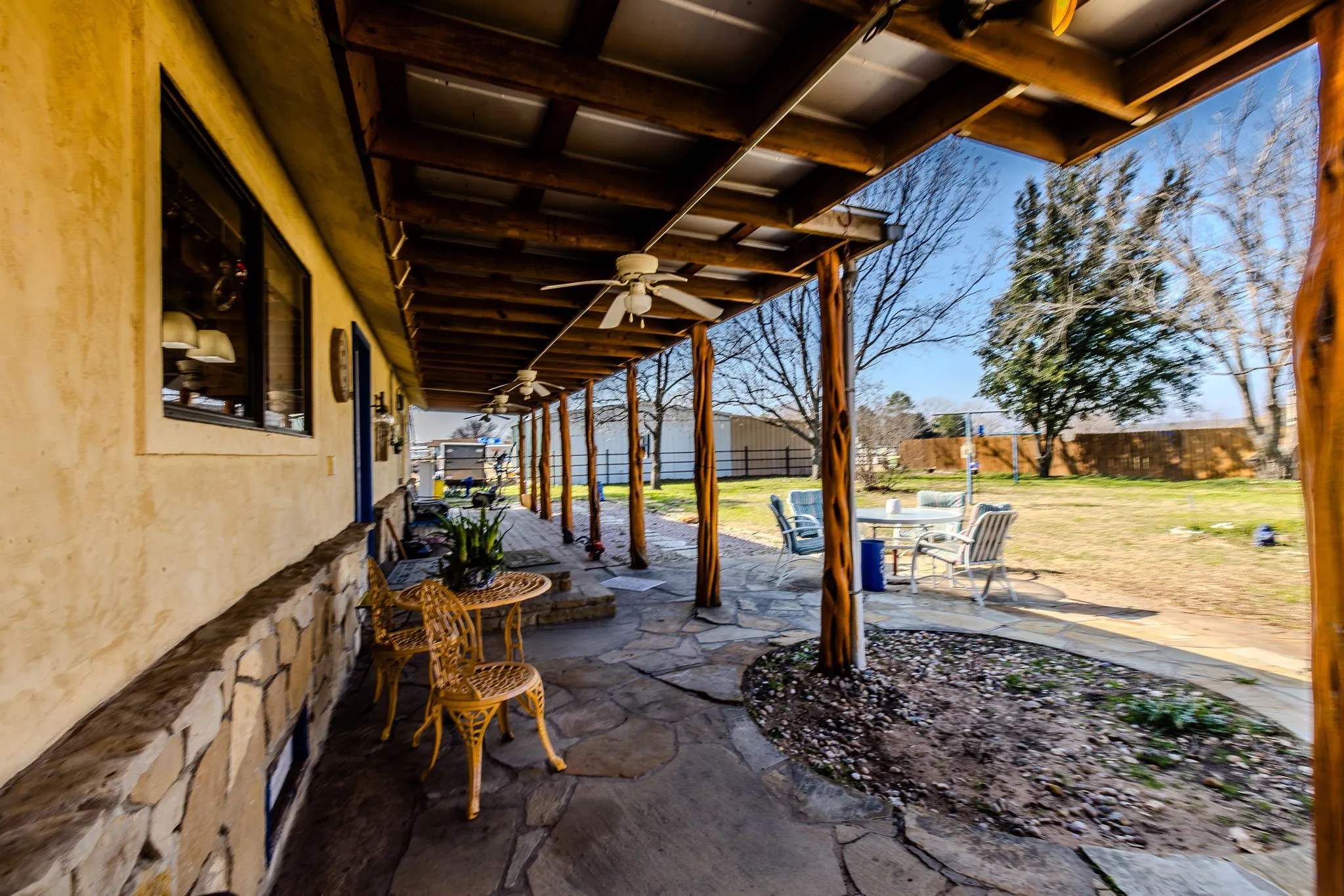 The covered back porch runs the length of the house and salon with back door entries into each.