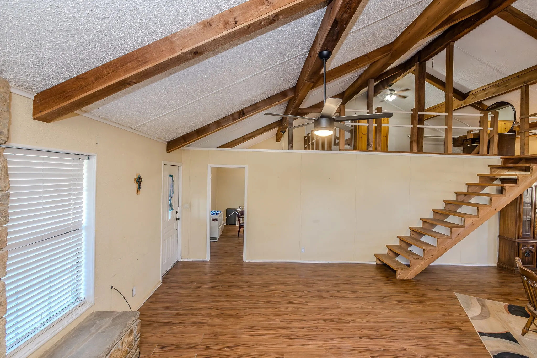Stairway to the loft; doorway to the office, which could be used as a bedroom.