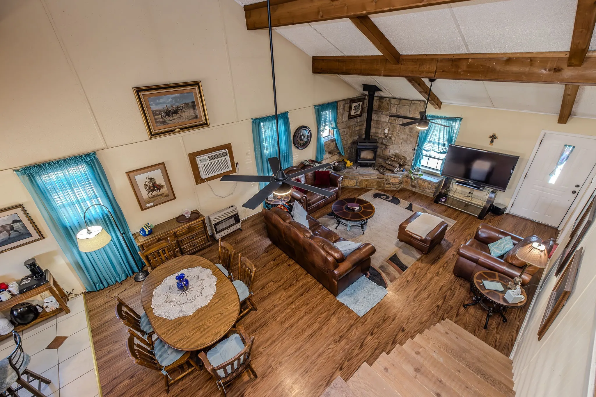 View of dining area and living room from loft, prior to removal of furniture.
