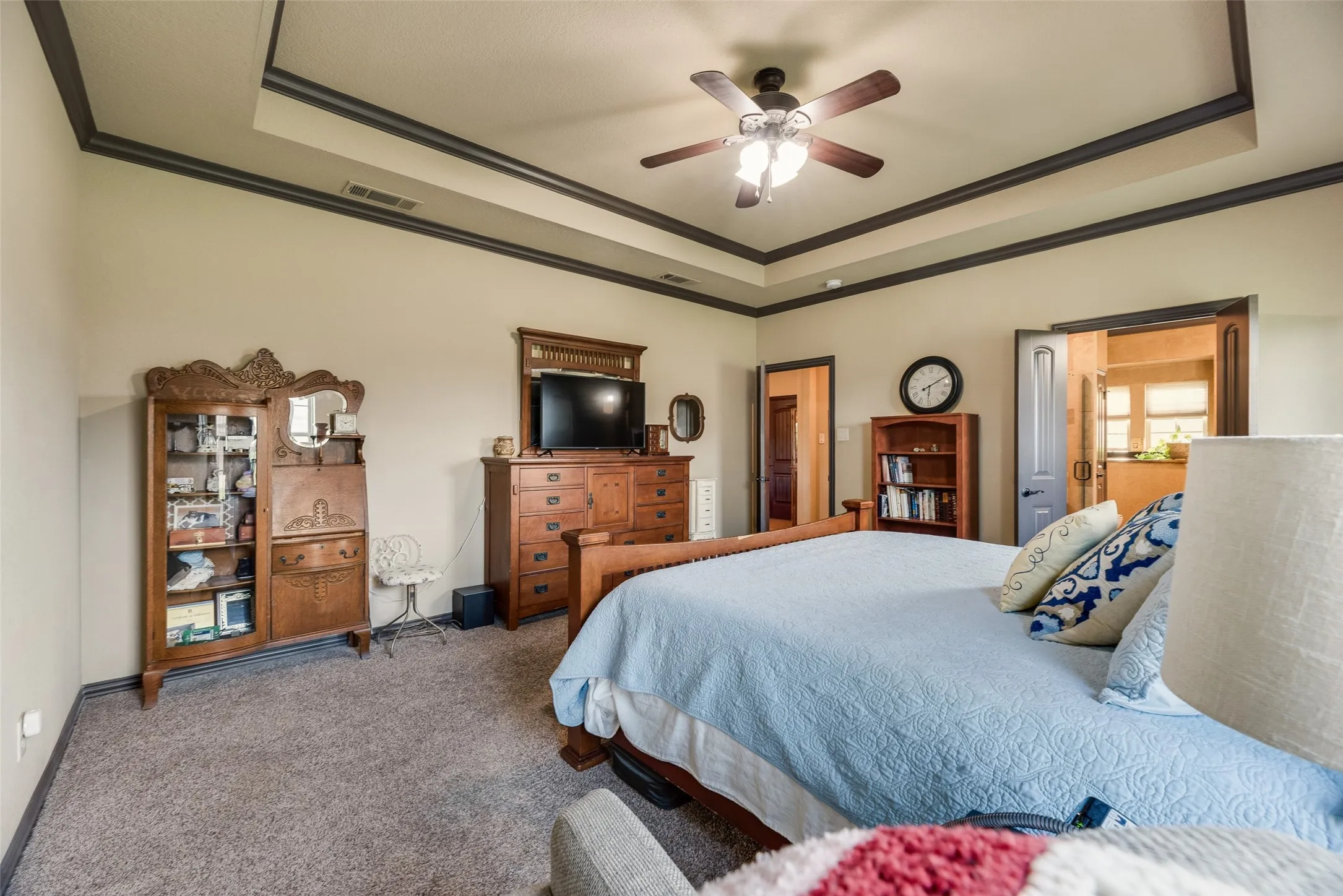 Carpeted room featuring a tray ceiling with dark trim, a ceiling fan, and recessed lighting