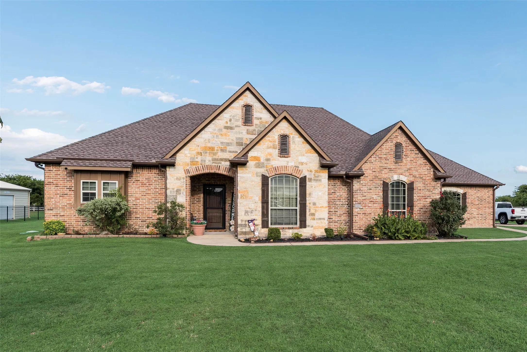 Exterior featuring a prominent brick and stone facade with arched entryways