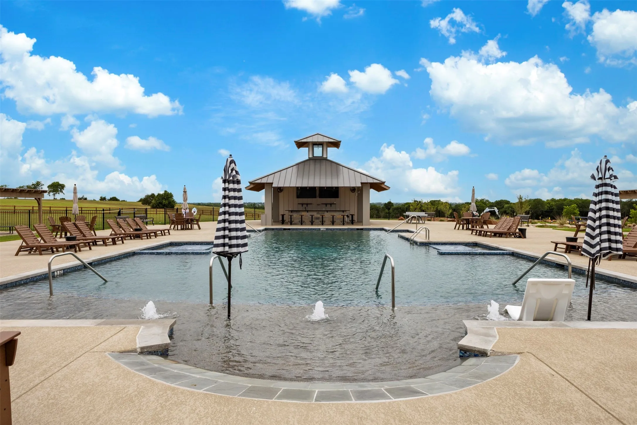 Resort style pool with bar and patio furnishings
