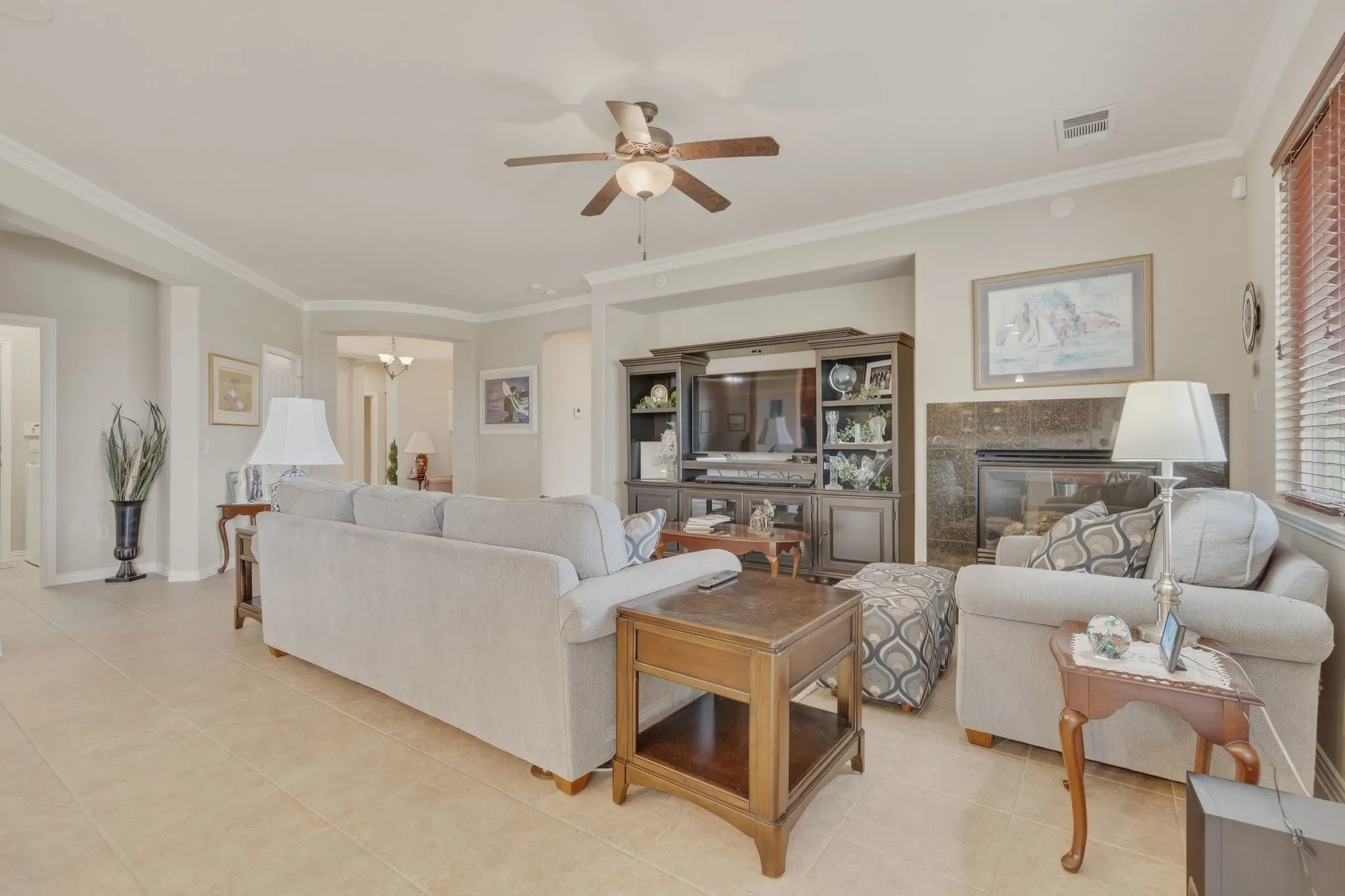 Large living room offers gas log fireplace and large TV niche