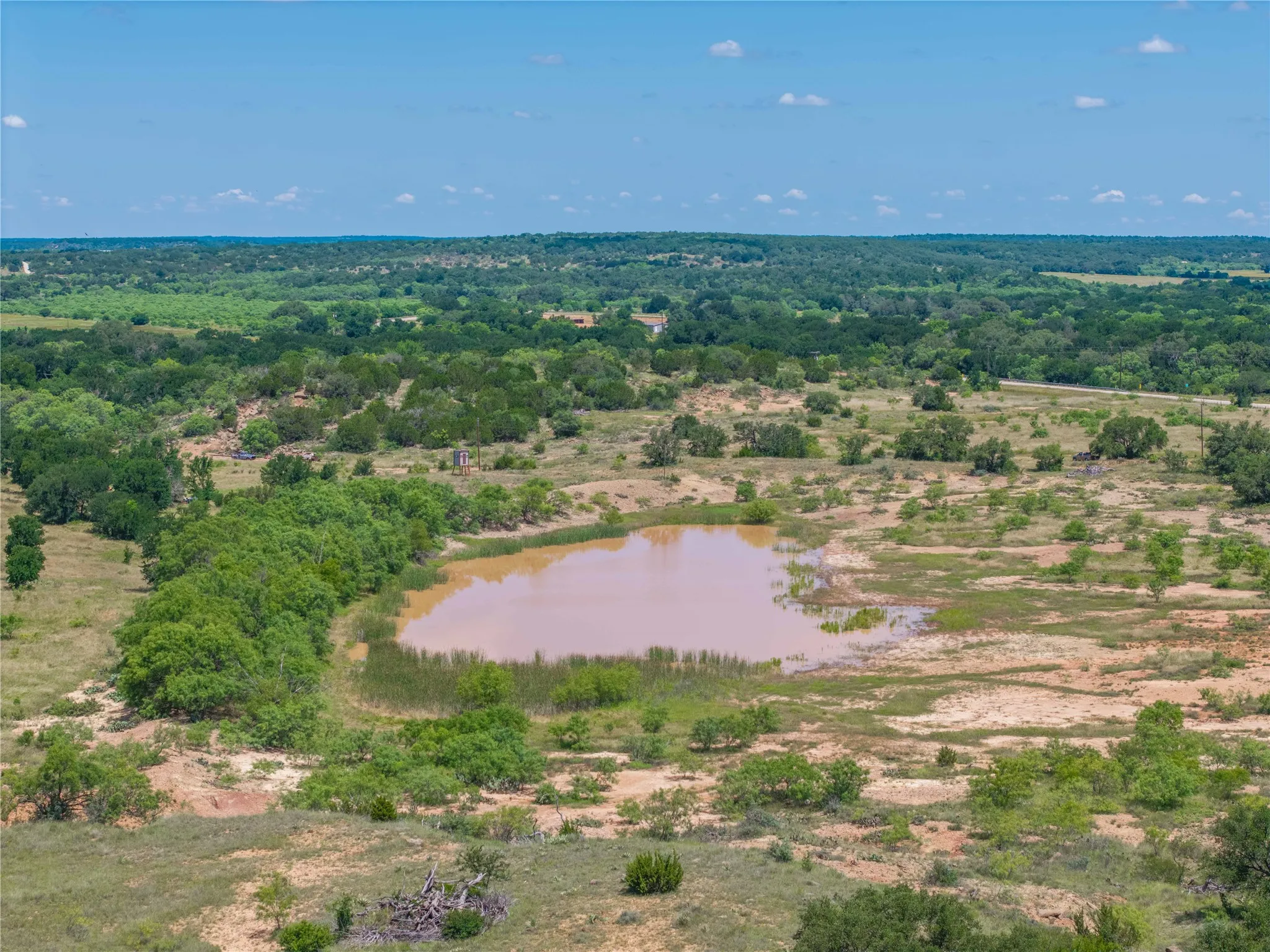 Expansive acreage featuring a natural water body and varied topography