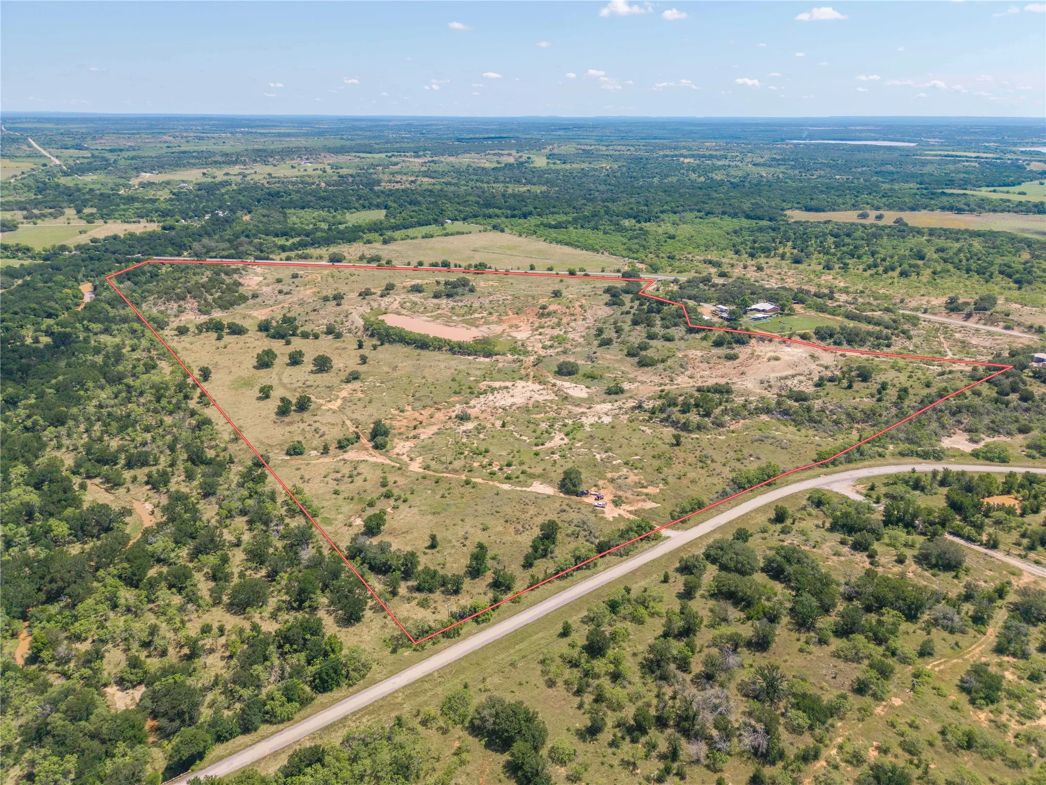 Expansive land parcel featuring diverse topography and abundant natural vegetation
