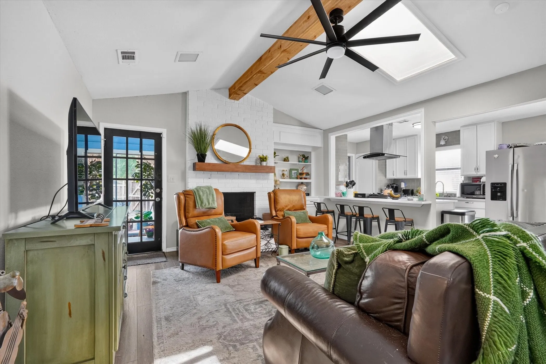 Family room with views of enclosed back patio and cook's delight kitchen
