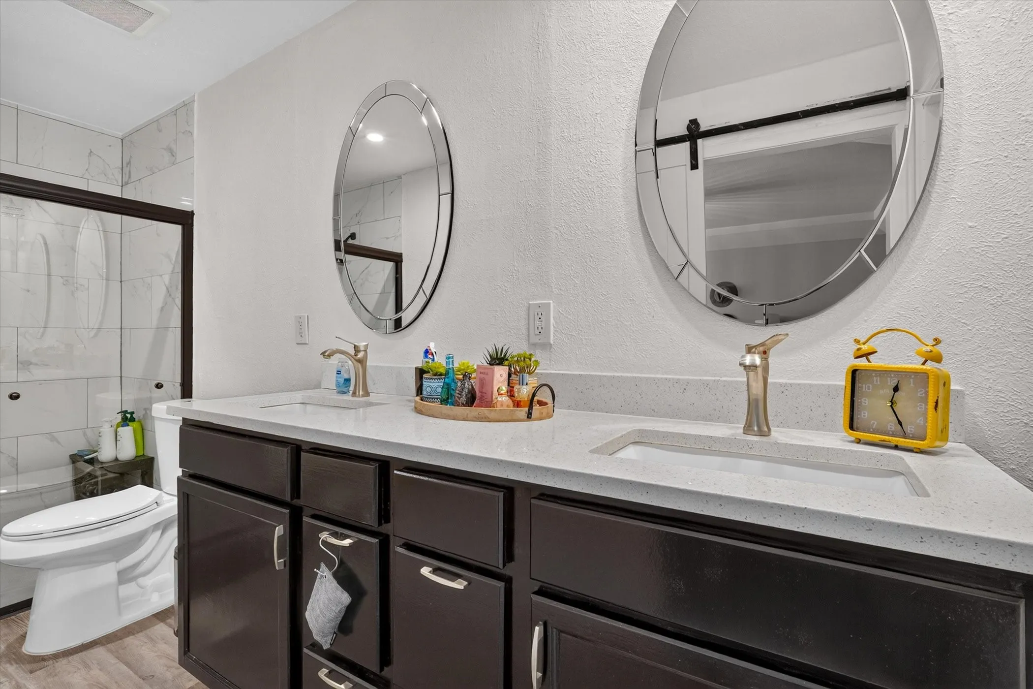 Primary bathroom with lots of cabinet space and stone counters