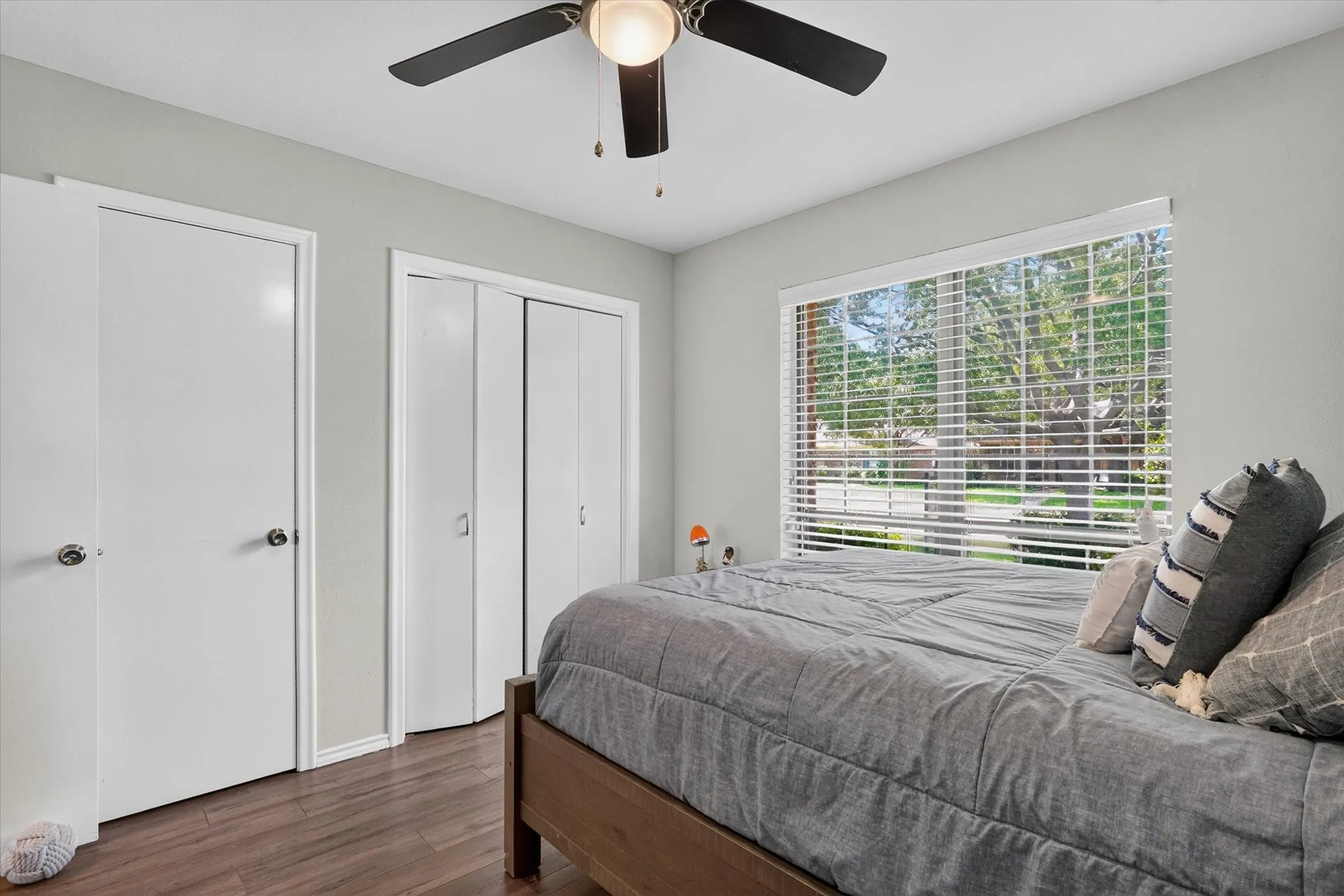 Bedroom #3 with ceiling fan and wood-like flooring and 2 closets