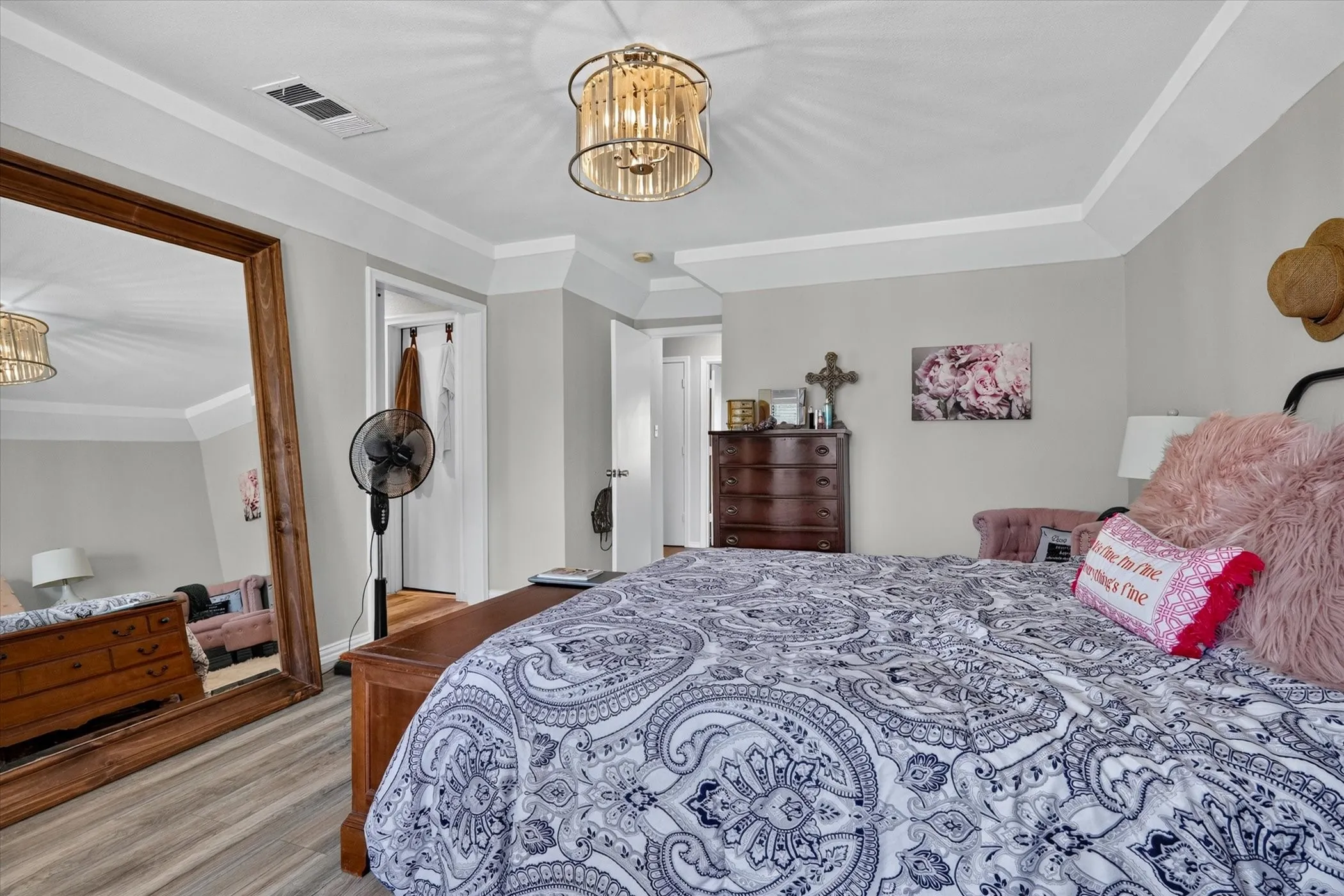 Large Primary bedroom with lovely chandelier and tray ceiling