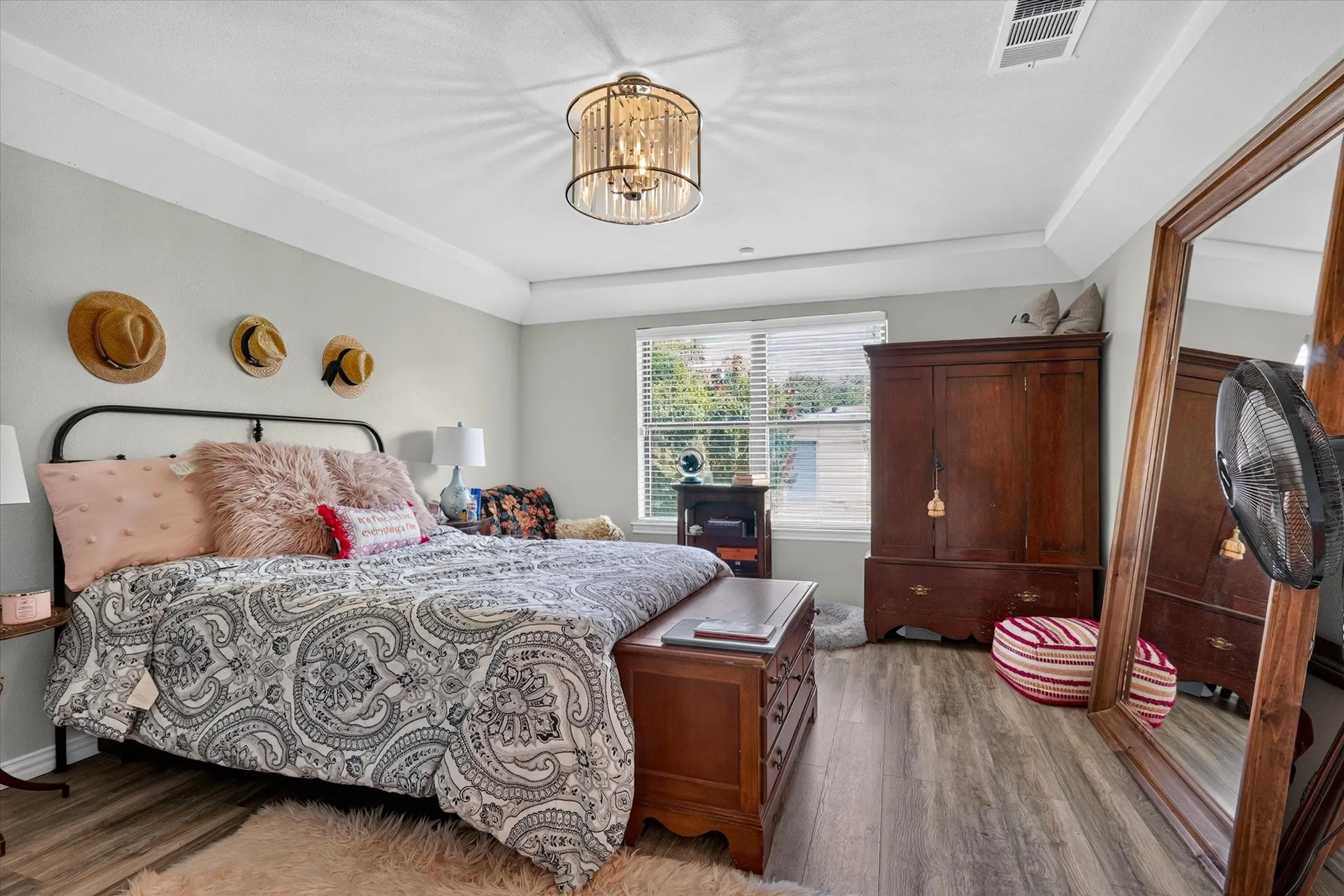 Primary bedroom with view of lush backyard