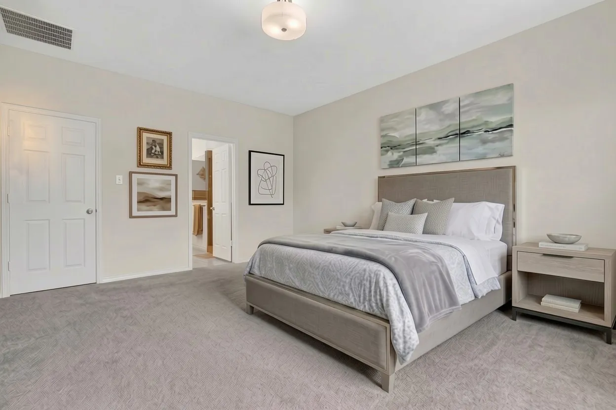 Neutral-toned bedroom featuring light grey carpeting and a flush mount ceiling light