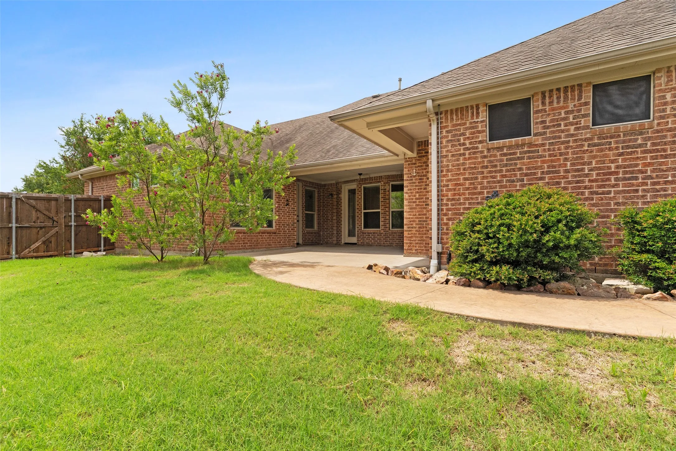 Back covered porch leading to yard and pool