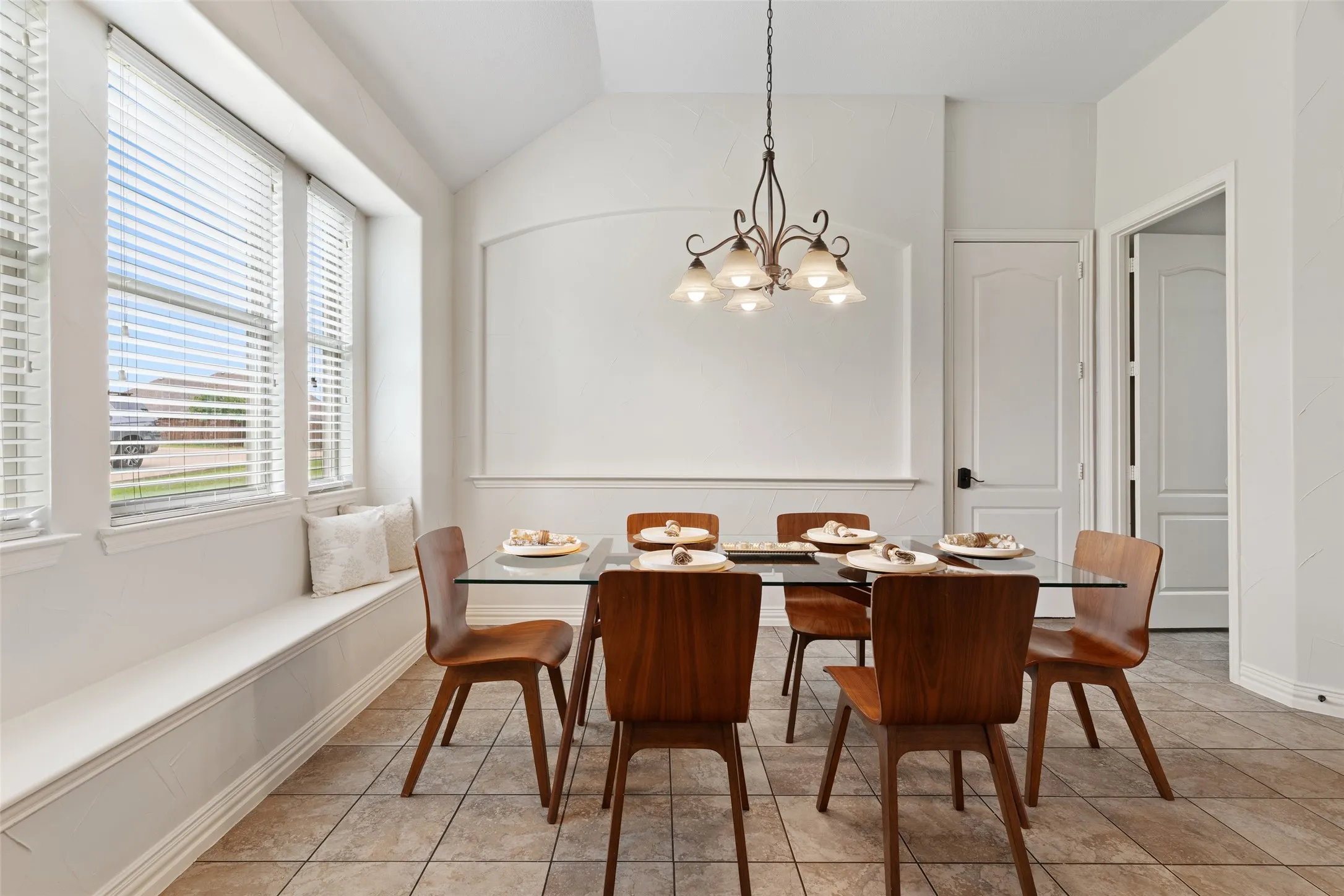 Casual dining with laundry room to the right and exit to garage.