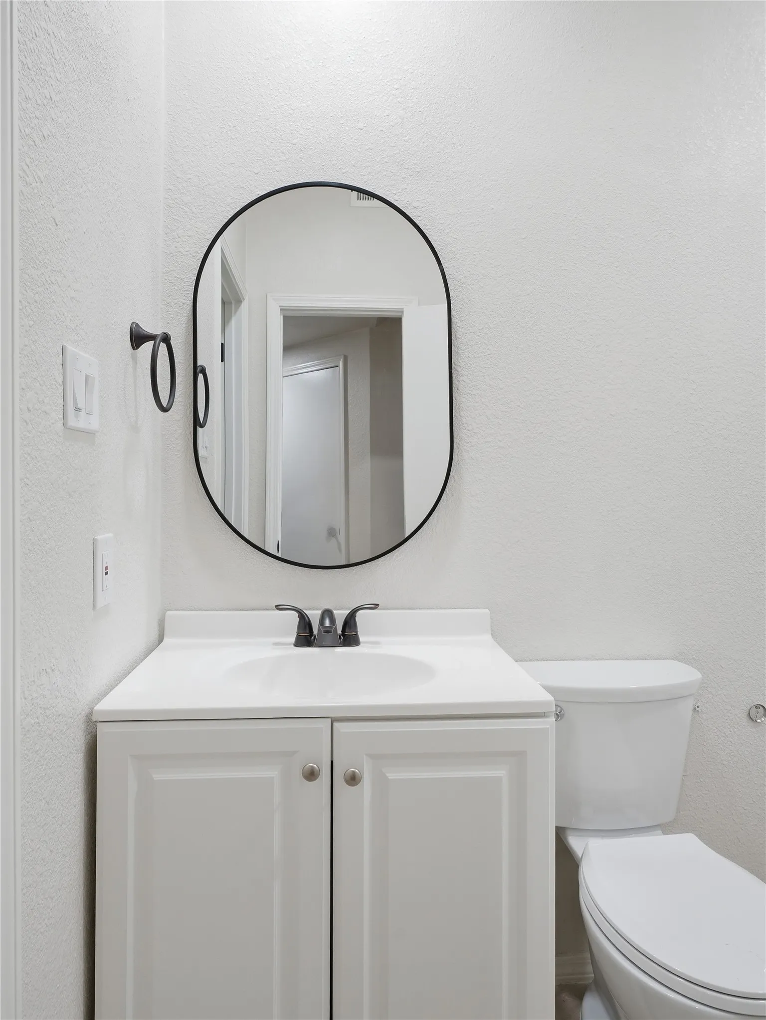 White vanity with an integrated sink and two-door cabinet storage