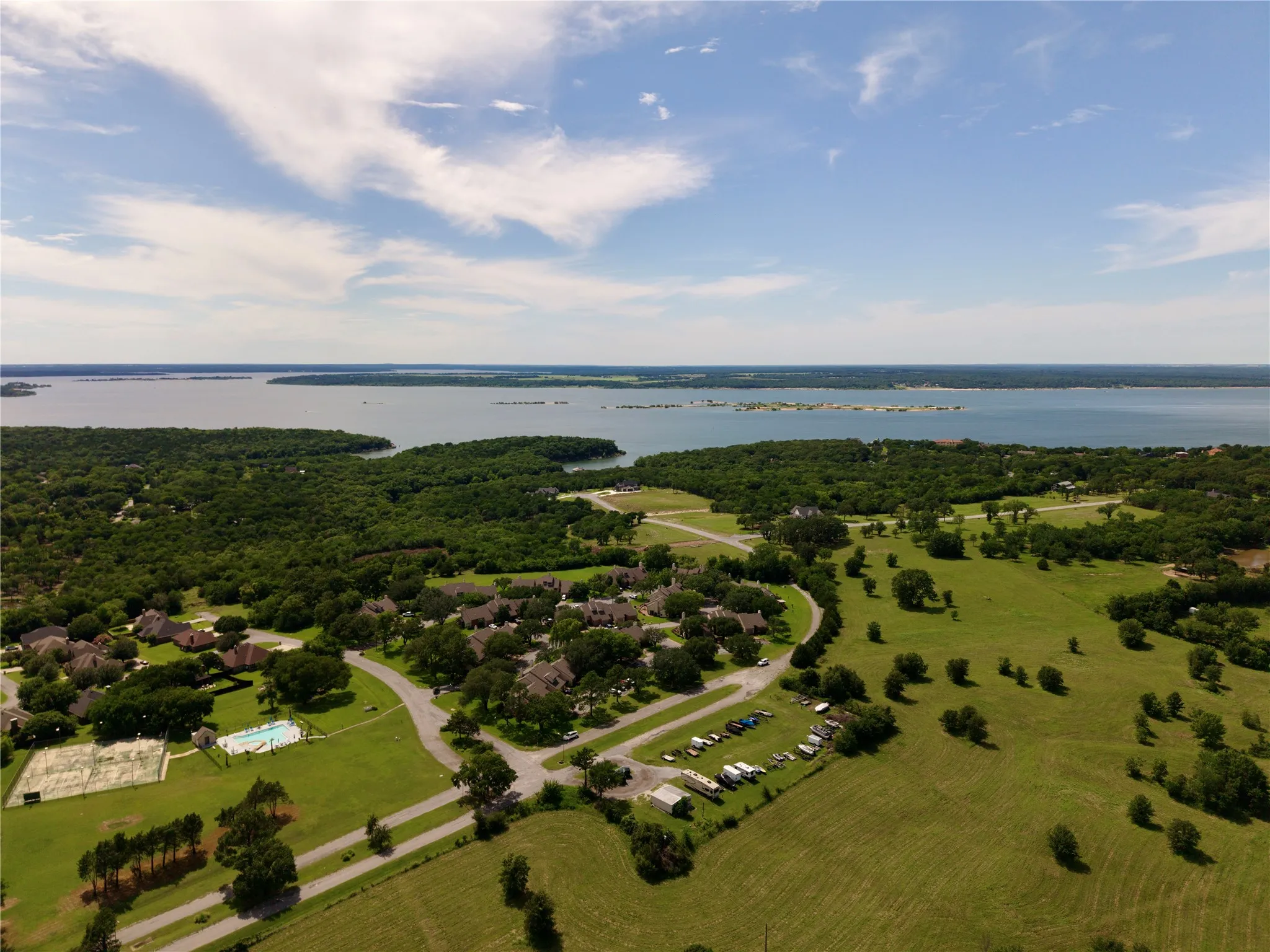 Expansive aerial showcasing a significant body of water bordered by lush green landscapes