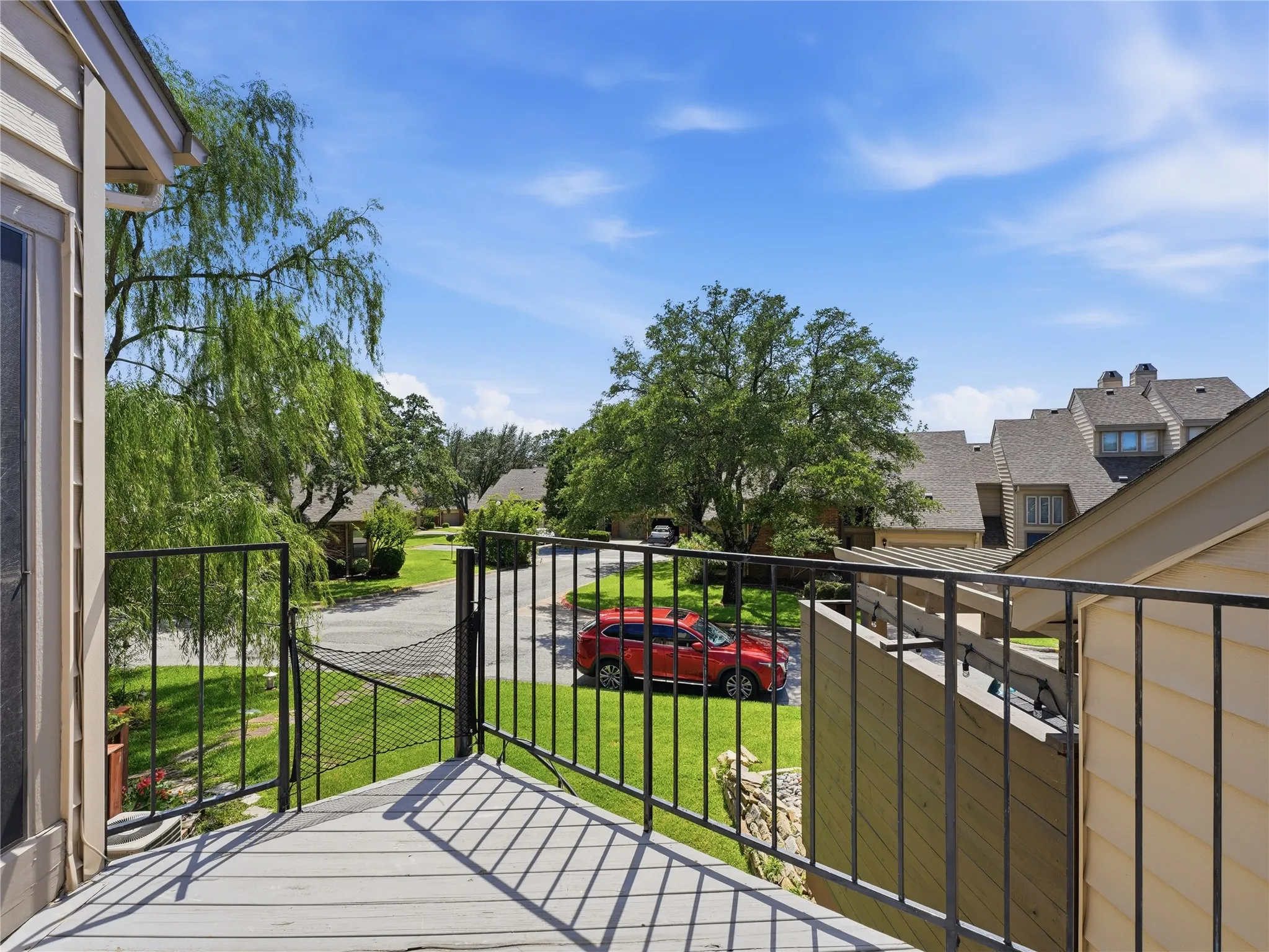 Exterior balcony featuring composite decking and black metal railings