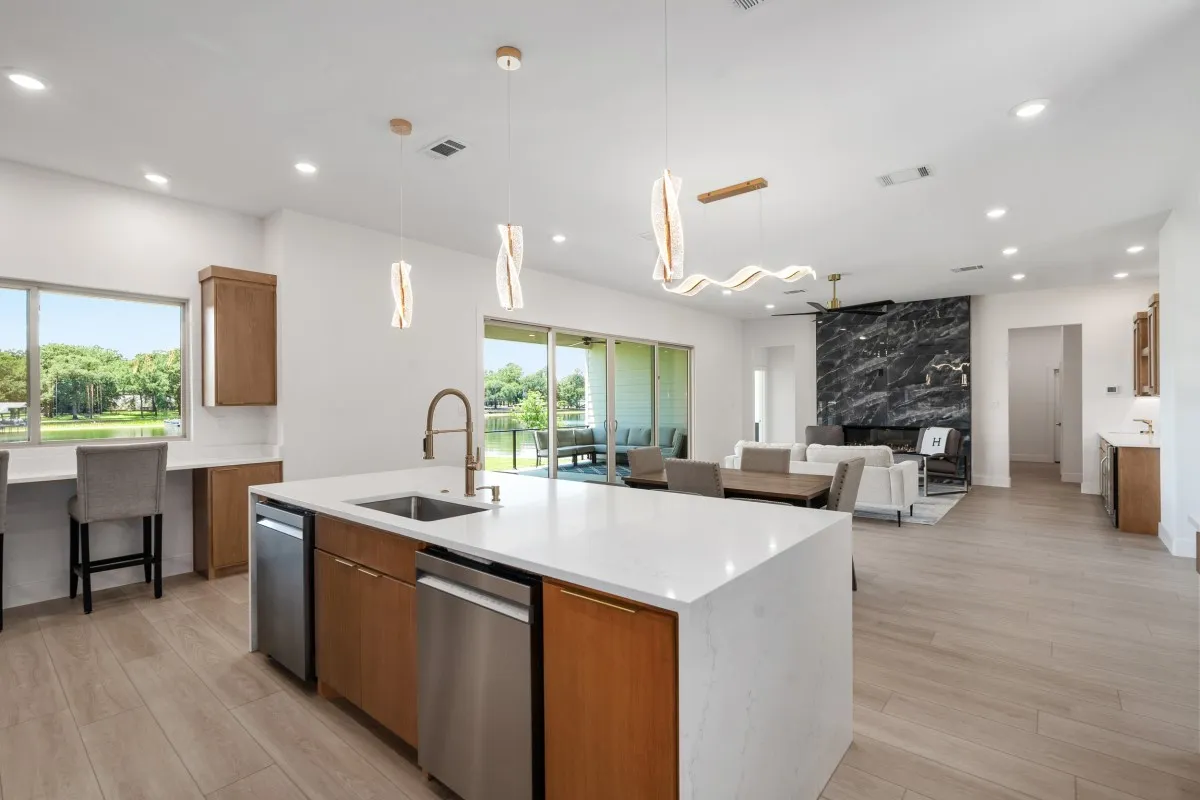 Open-concept living, dining & kitchen with panoramic water views.