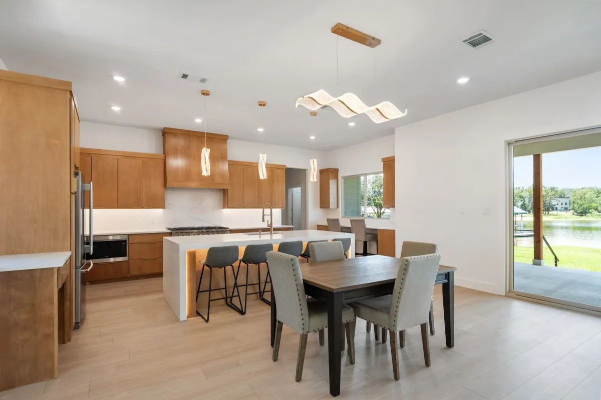 Open-concept living, dining & kitchen with panoramic water views.