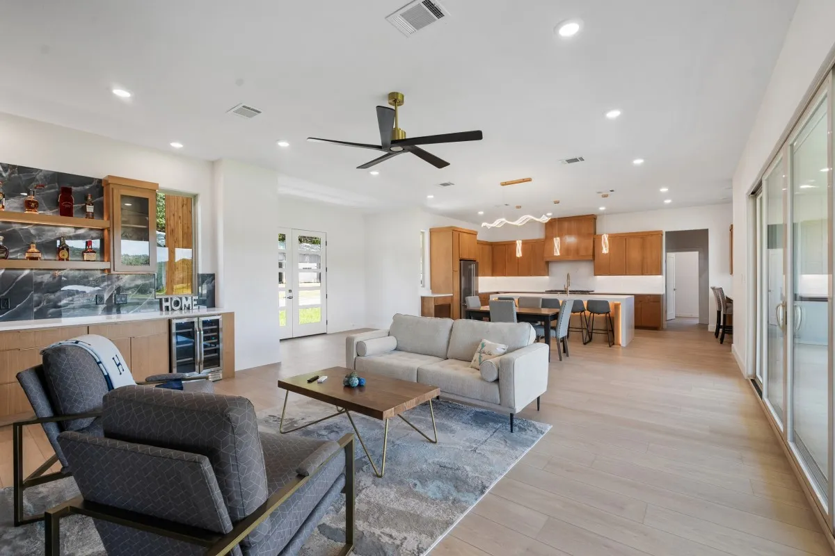 Open-concept living, dining & kitchen with panoramic water views.