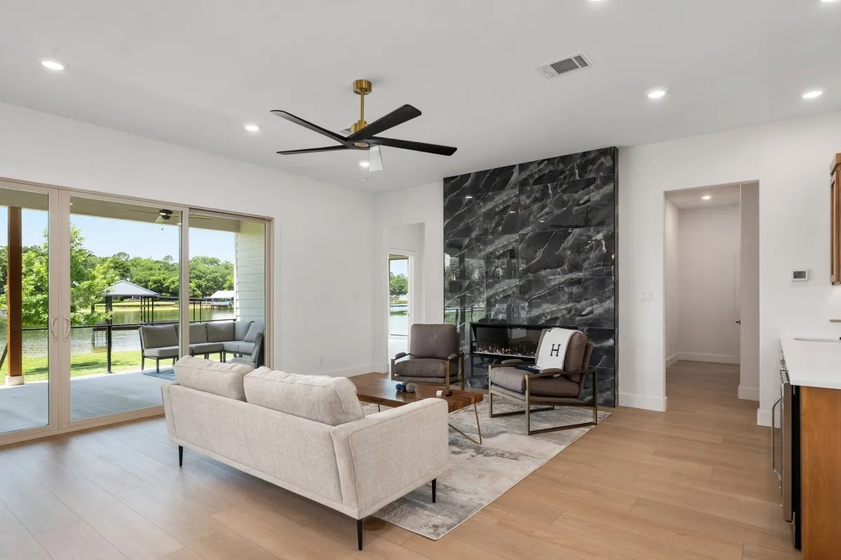 Open-concept living, dining & kitchen with panoramic water views.