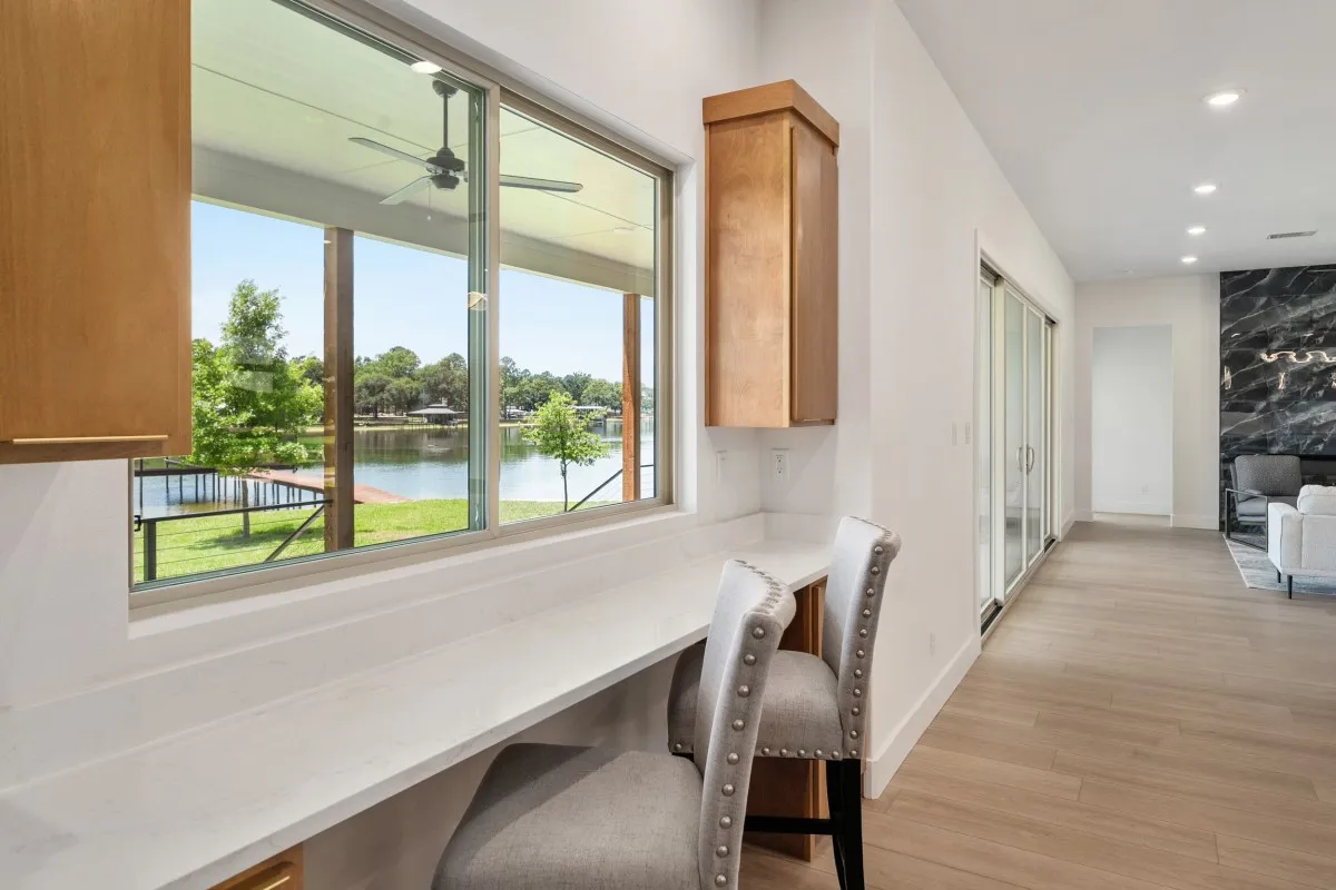 Open-concept living, dining & kitchen with panoramic water views.