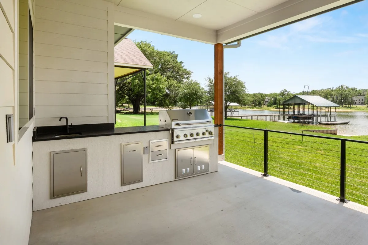 Large covered outdoor patio with kitchen and spacious seating for entertainment.