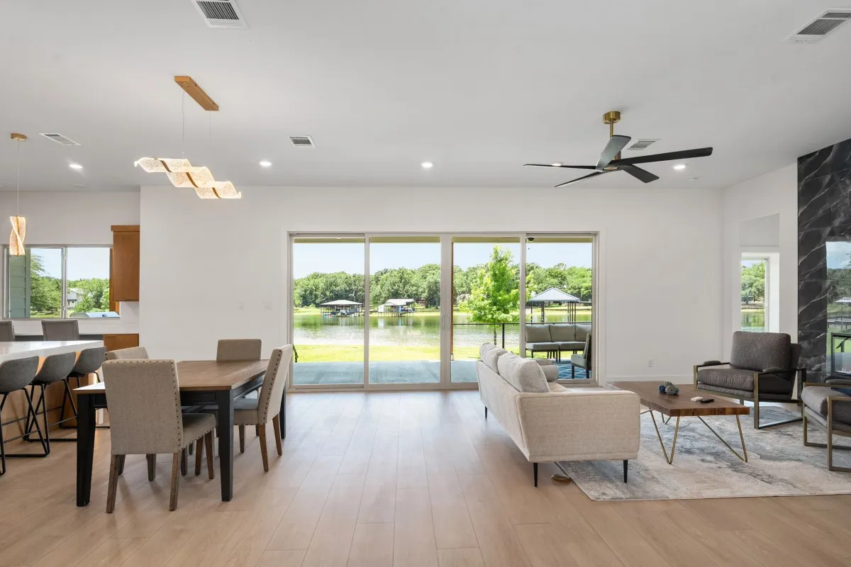 Open-concept living, dining & kitchen with panoramic water views.