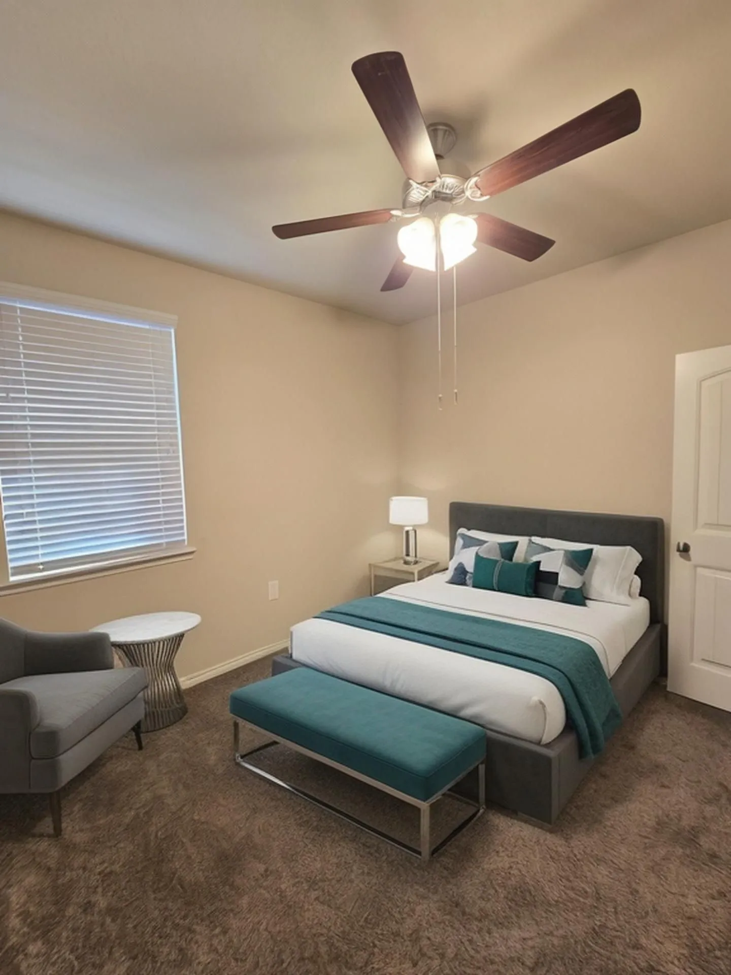 Bedroom featuring neutral-toned walls, plush carpeting, and a ceiling fan with integrated lighting